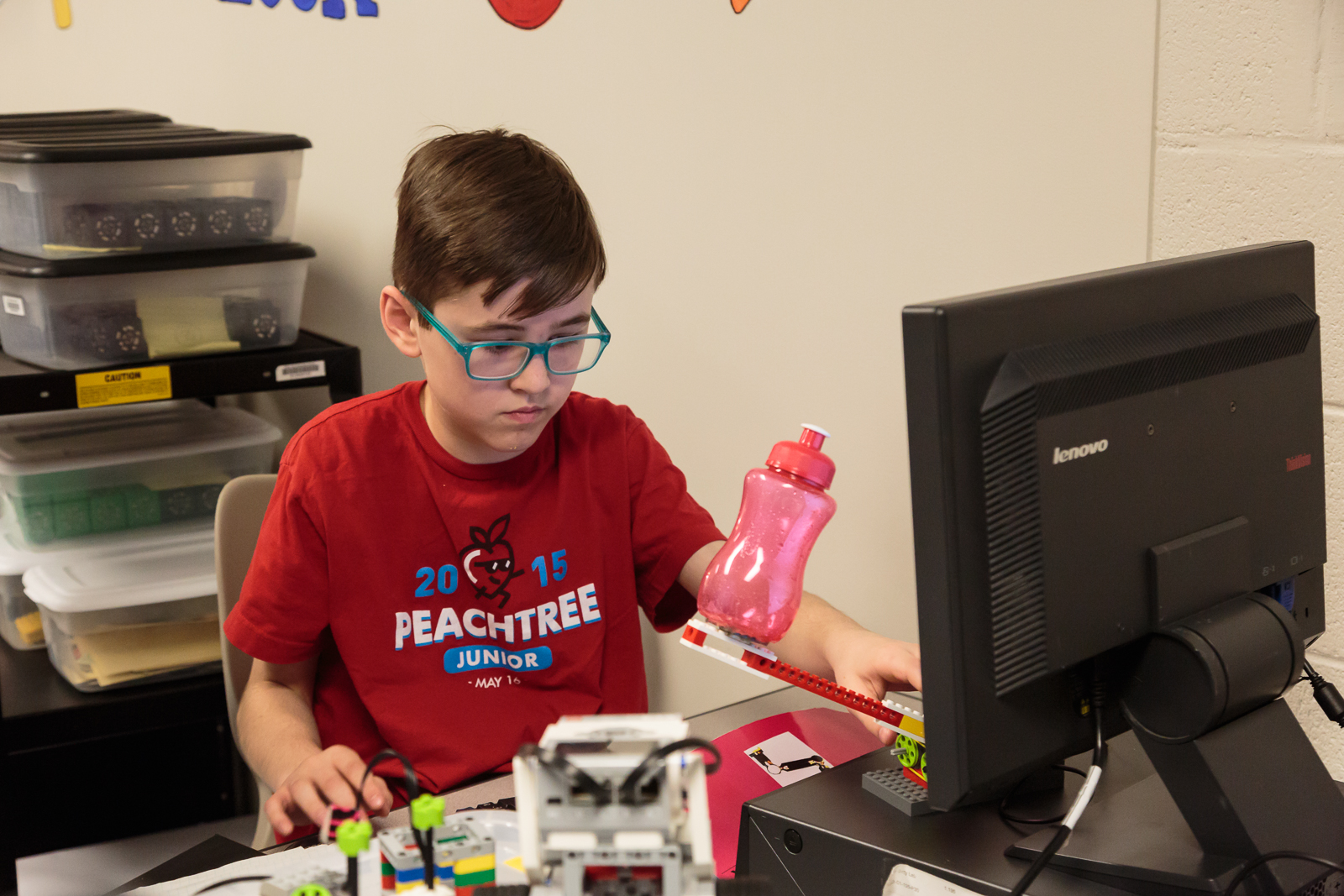 Carter and Isabel , both 4th graders, explained how they (with teammates Braden and Anthony ) designed a bottle to make drinking beverages easier for individuals with disabilities and for small children. The group built a motorized prototype using LEGO bricks and powered by code written by the students.