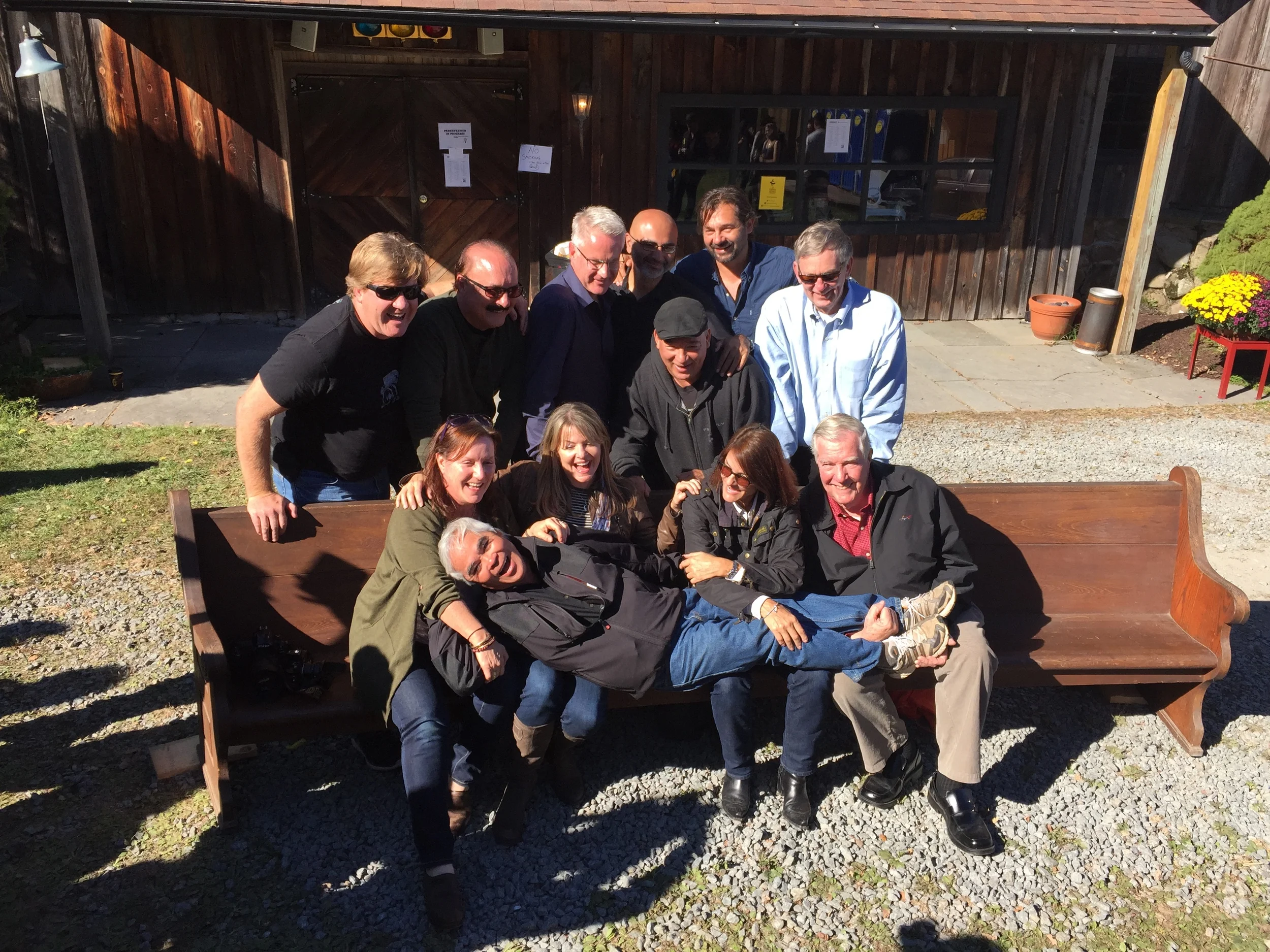 Photo of 13 Pulitzer Prize winners. They are, from left to right: (back row) Tim Rasmussen, Colin Crawford, John Moore, Adrees Latif, Daniel Berehulak, Tom Kennedy, (front row) Ruth Fremson, Deanne Fitzmaurice, Carolyn Cole, Hal Buell and Jimmy Colton. With Nick Ut laying across the front row's laps.