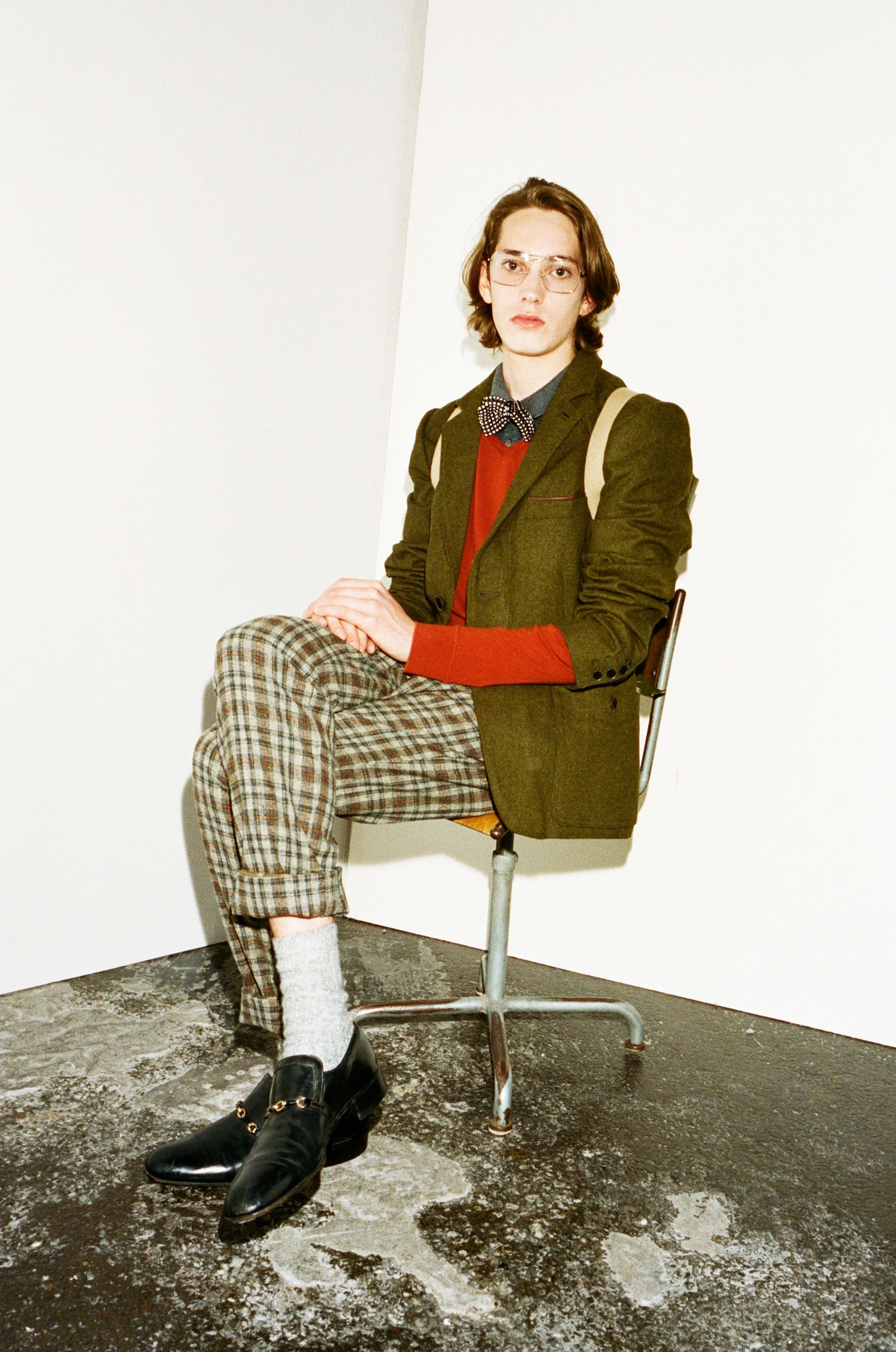 Mees wears Grey Polo Top by Barbour, Red V-neck Jumper by Paul & Joe, Khaki Blazer by Timberland, Tweed Trousers by Paul & Joe, Grey Socks by Falke, Black Shoes from Beyond Retro, Bow Tie from Beyond Retro, Glasses by Retrosuperfuture 
