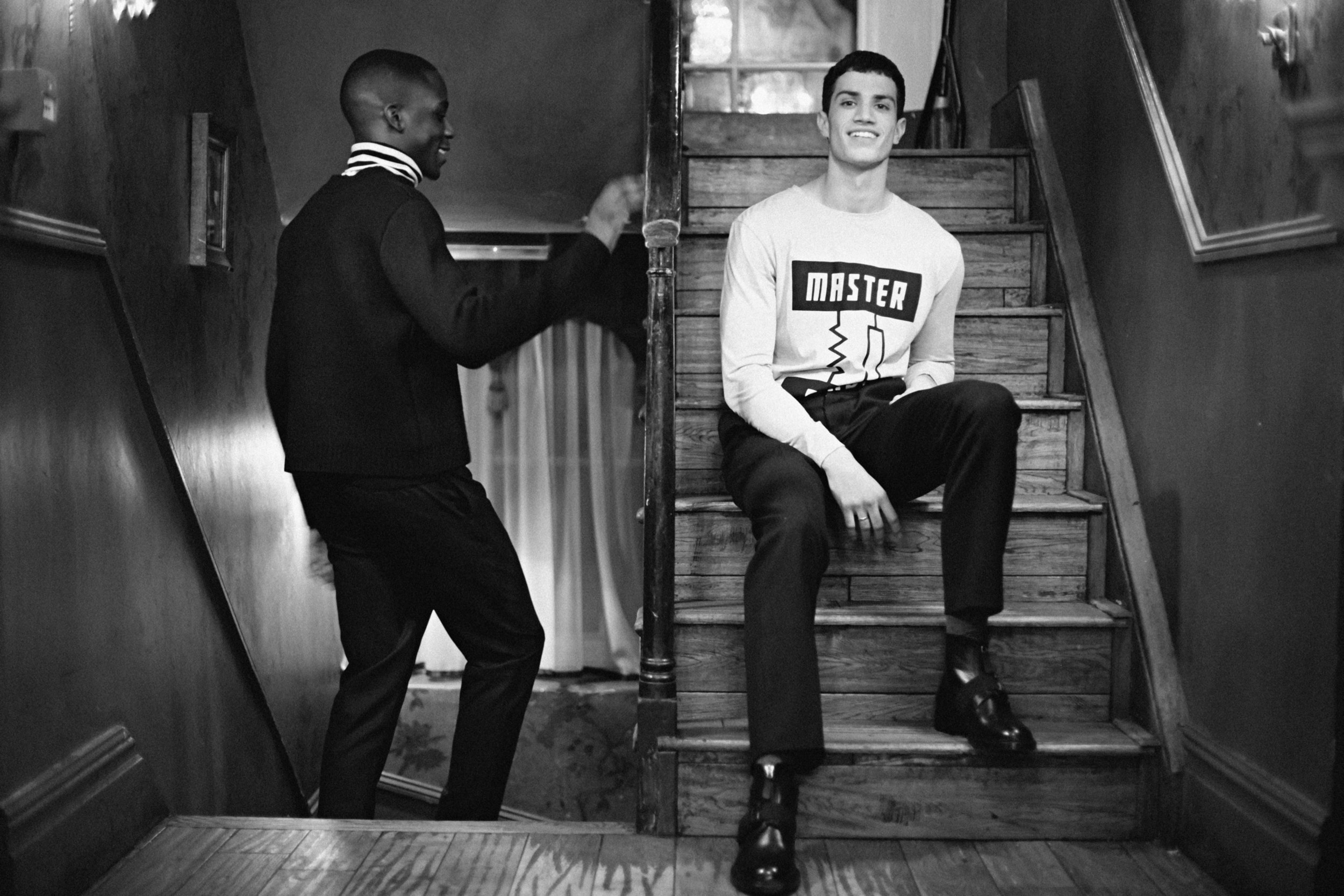 Emmanuel wears Jumper by Craig Green, Turtleneck worn underneath by Esk, Trousers by Christopher Kane and Sneakers by ISSEY MIYAKE MEN Ashton wears Long Sleeve Top by Studio White Label, Trousers by Markus Lupfer and Boots by Christopher Kane