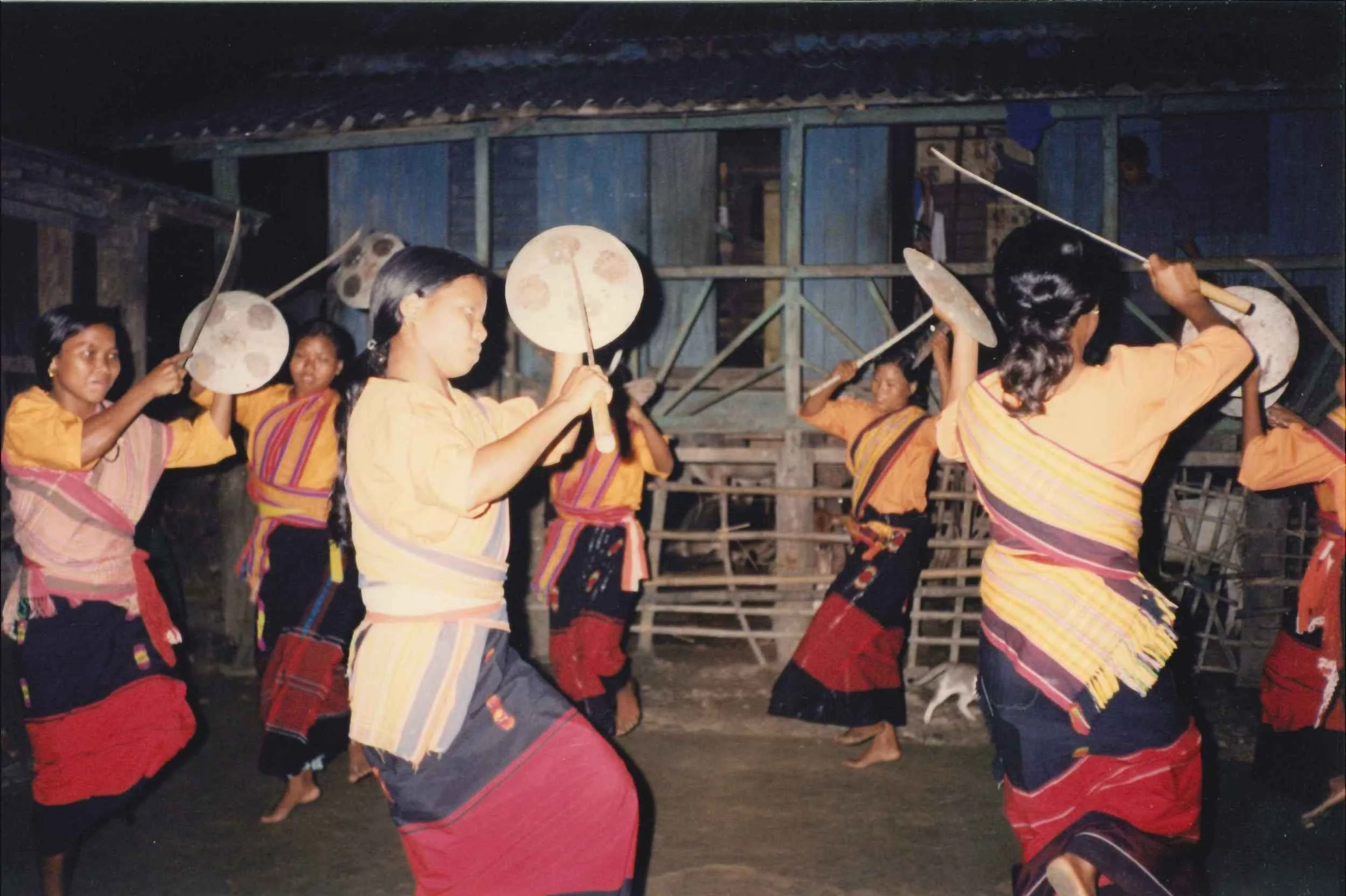 Rabha tribe girls dancing in their traditional costumes in a forest village in West Bengal