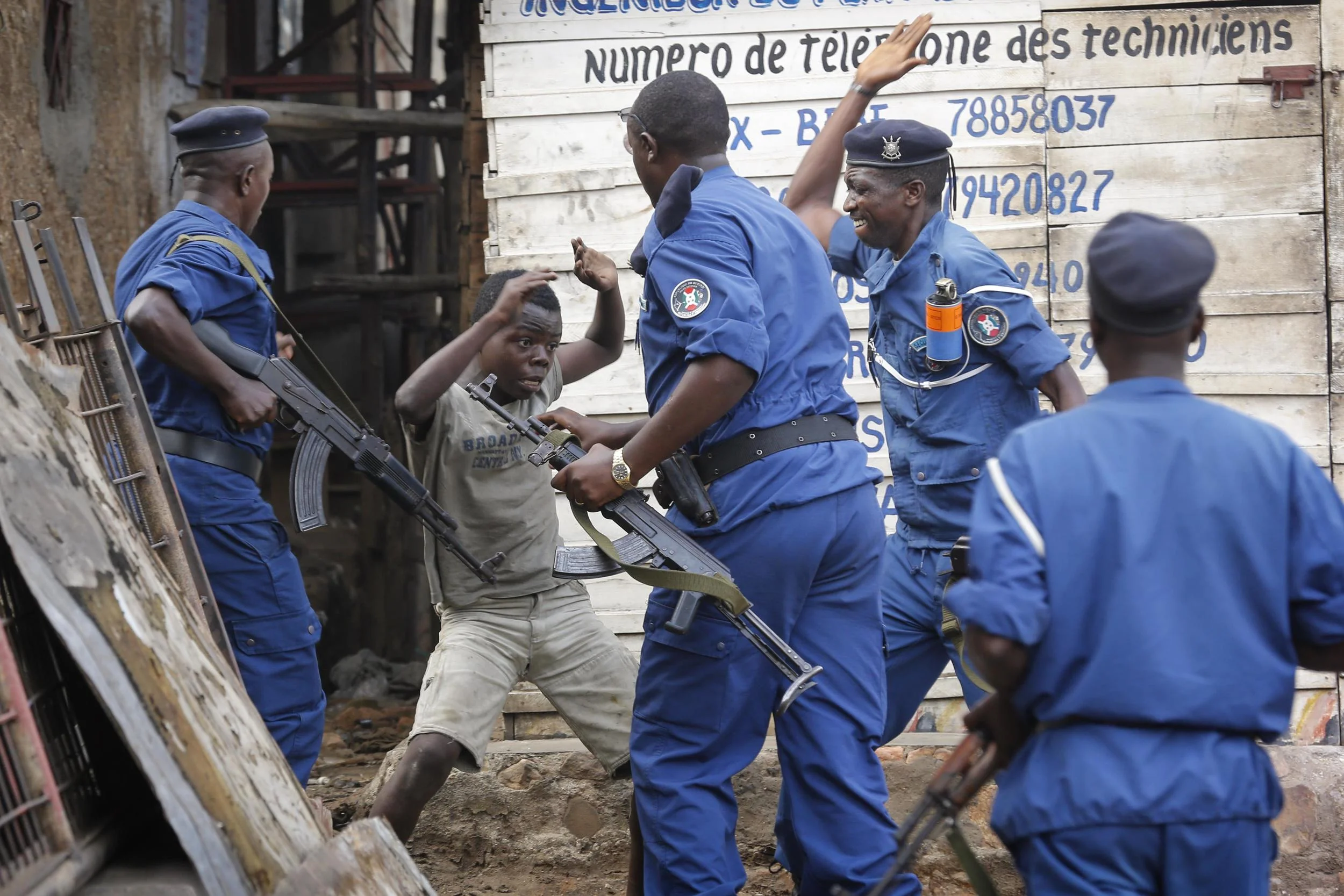 A young Burundian boy beaten by armed police officers during protest in Bujumbura over president's third term, 2015 photo by Dai Kurokawa / EPA