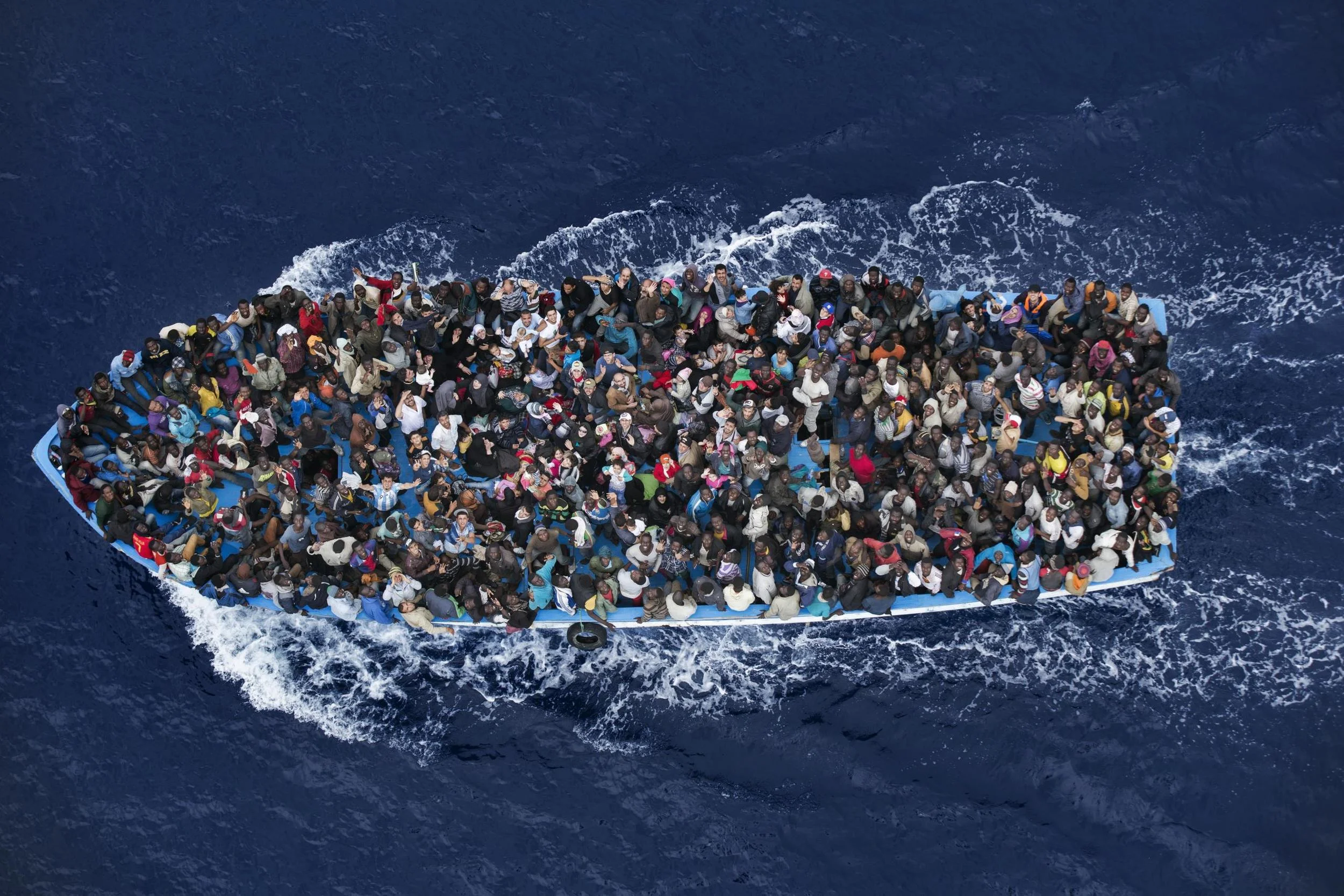 Asylum seekers from Africa traveling by boat in the Mediterrancean, 2014. Photo by Massimo Sestini