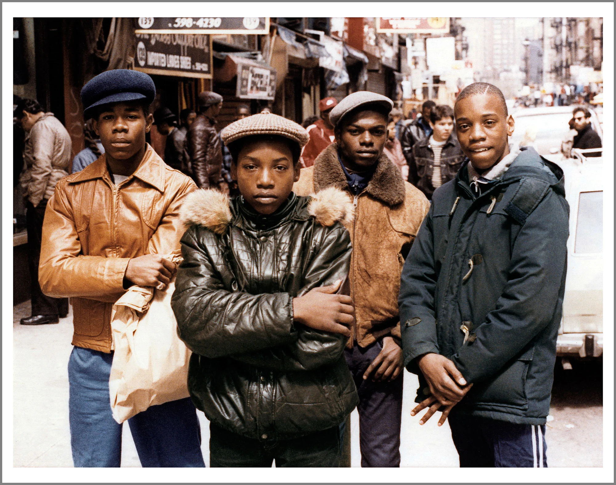 Portrait of four young men as they pose on the Lower Eastside, New York, 1982. Photography by Jamel habazz.