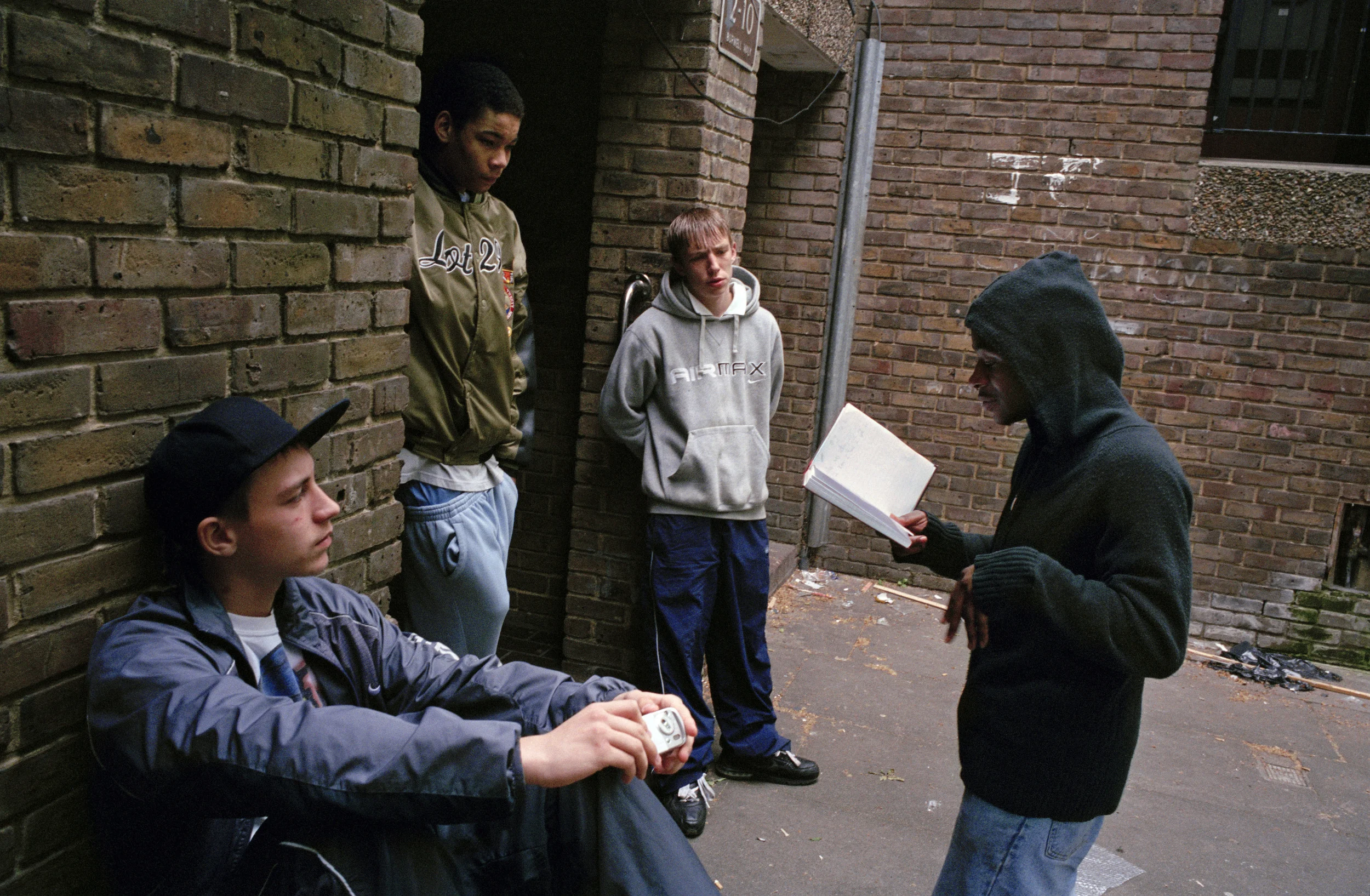 A young grime emcee recites his rhymes on a housing estate in Bow, East London. 2006 by Simon Wheatley