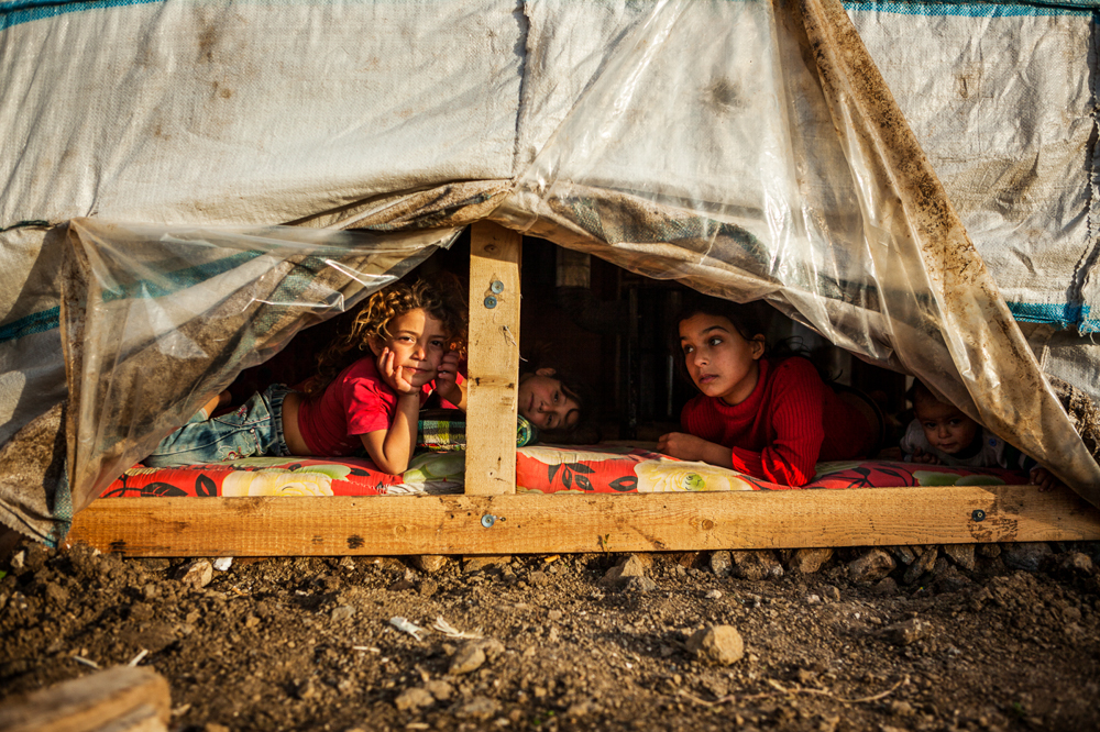 A space of their own. With gripping poverty now confronting over half of the Syrian refugee population in Lebanon, play for Syrian children is, often without toys, reduced to imagination and invention. Helba, Tripoli, Lebanon. February 4, 2016. Photo by Danish Refugee Council/Eduardo Soteras Jalil.