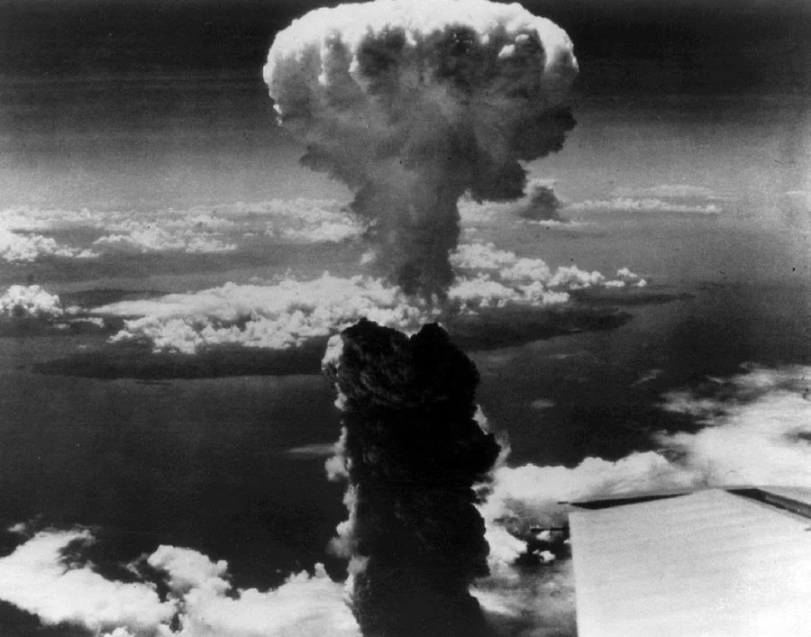 Smoke billows over Nagasaki, Japan after the atomic bomb was dropped on the city on 9th August 1945. Photo source: Reuters.