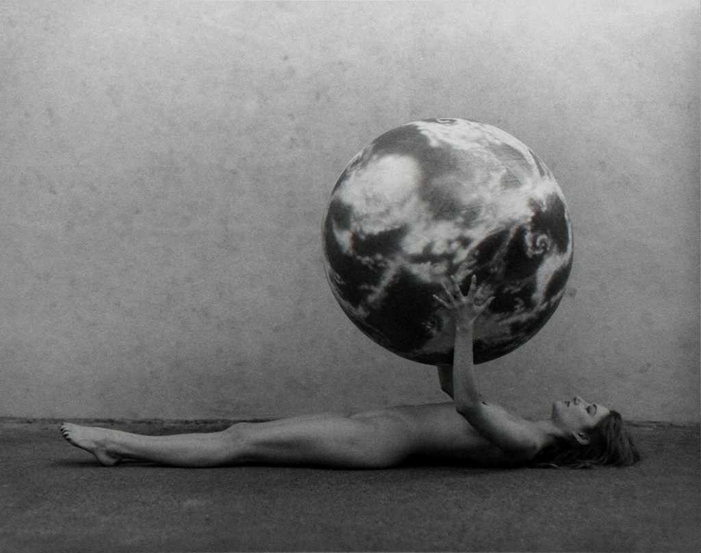 Undated photograph of Nude Woman with Model of the Earth by Spencer Tunick.