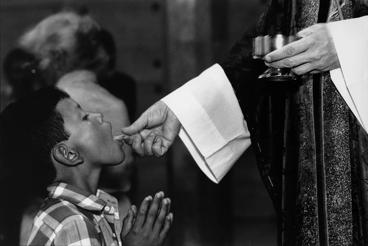 Sunday's church communion in El Salvador by Mike Goldwater.