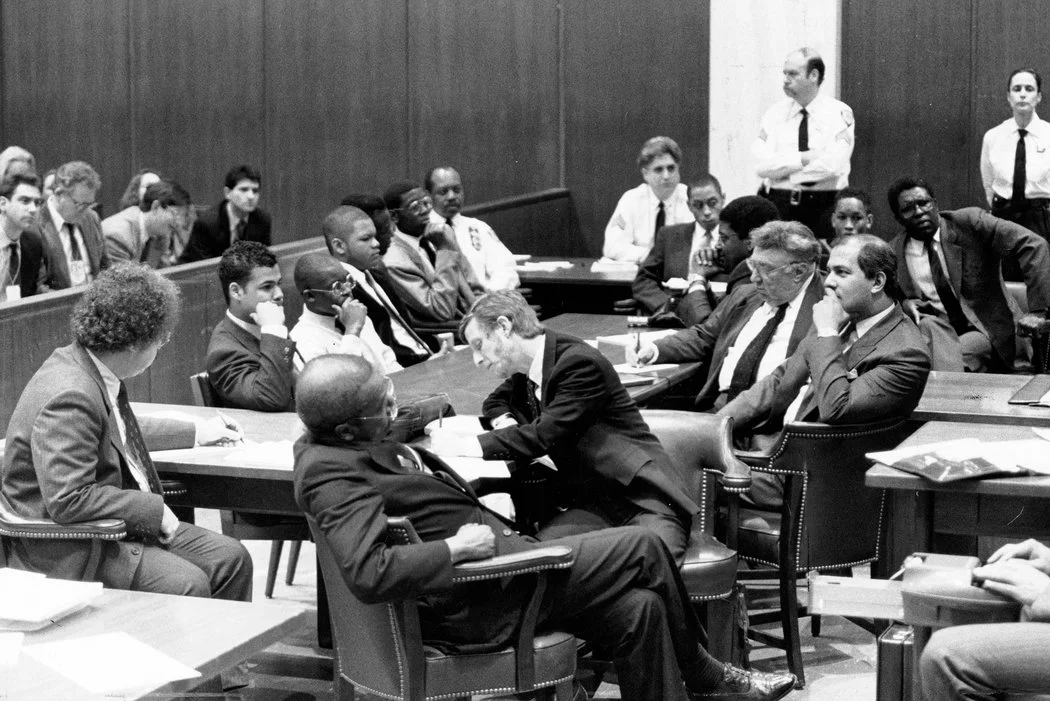 Lawyers, in foreground, and the five defendants in the Central Park rape case of a female jogger waiting for the ruling in February 1990 in State Supreme Court in Manhattan. Photo by James Estrin for The New York Times .