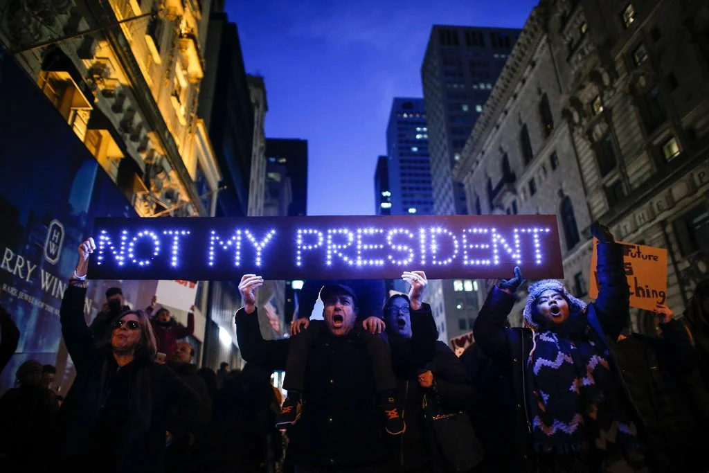 People gathered outside Trump Tower to protest the election of Donald J. Trump. Photo by Kena Betancur.