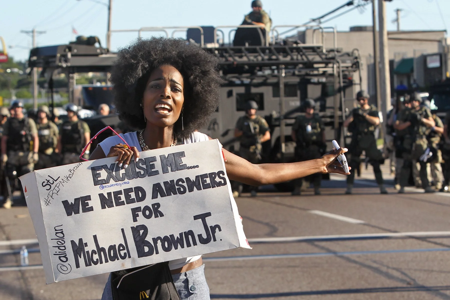 A protester shouts as she moved down W. Florissant Avenue away from the line of riot police in Ferguson on Wednesday, Aug. 13, 2014. Photo by J.B. Forbes.