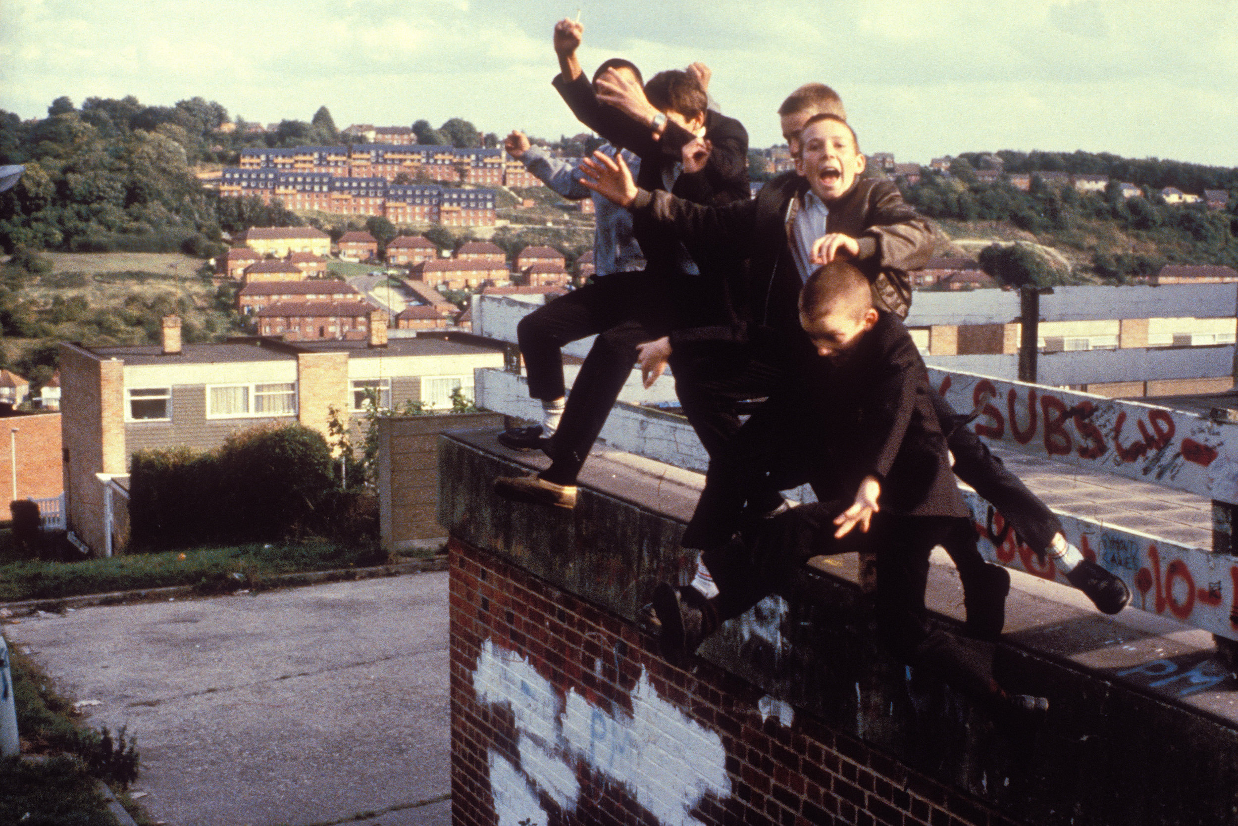 A group of Boys jumping off a roof, High Wycombe, UK 1980's. Photo by Gavin Watson.