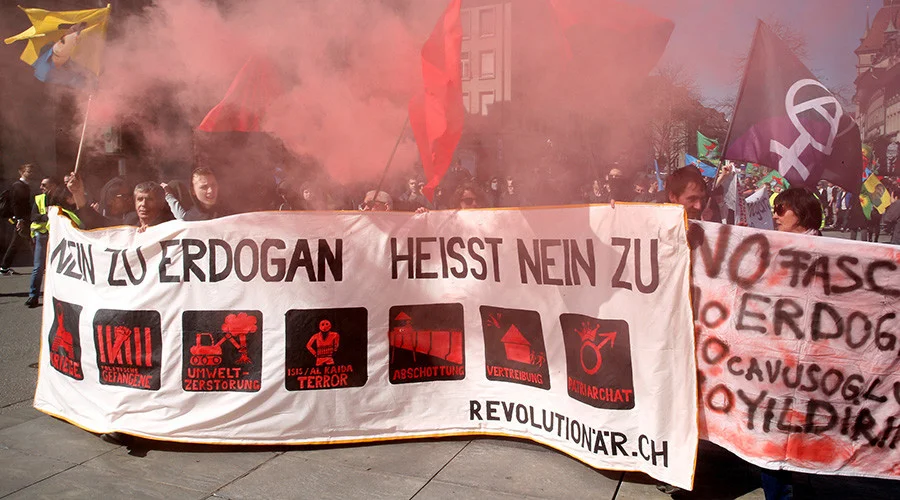 People hold banners and flags during a demonstration against Erdogan dictatorship and in favour of democracy in Turkey in Bern, Switzerland March 25, 2017. The banerr reads 'Say no to Erdogan'. Photo by Ruben Sprich for Reuters.