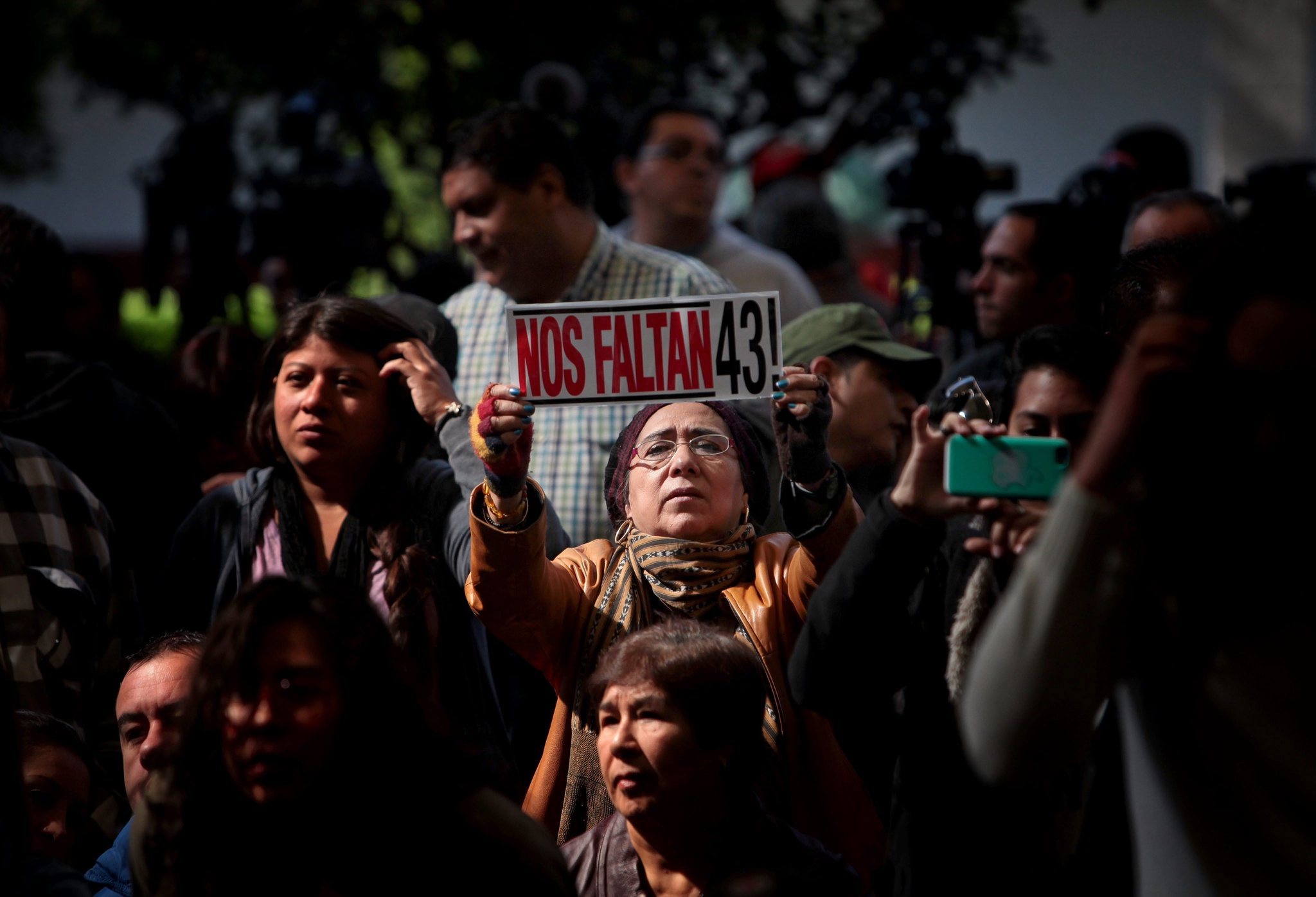 A woman's banner reads "We Are Missing 43!" at a presentation in Mexico City on Sunday to relatives of 43 missing Mexican college students from a school in Ayotzinapa. Photo by Sashenka Gutierrez for EPA.