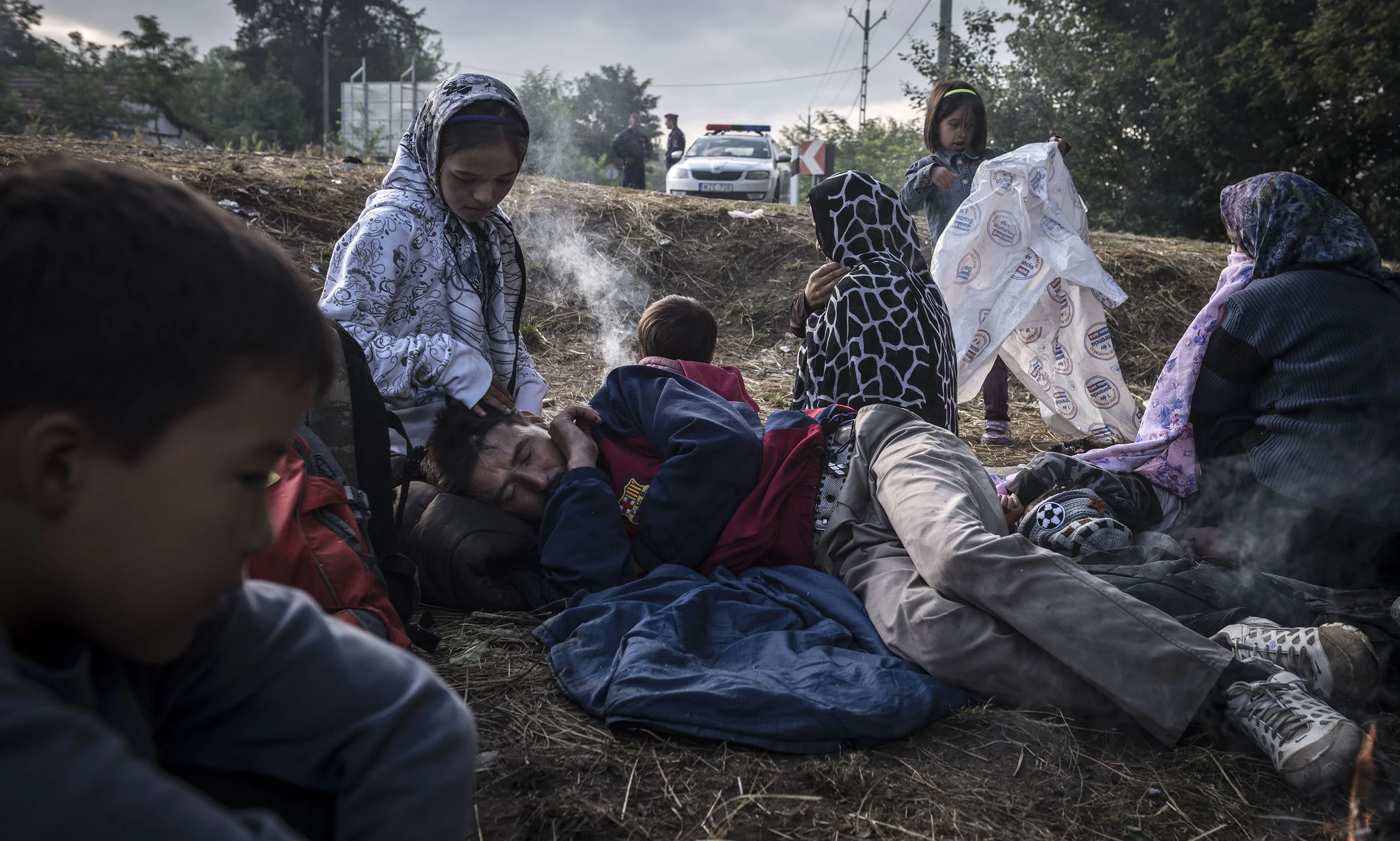 Migrants being detained by Hungarian police after crossing the Serbia-Hungary border outside Asotthalom, Hungary. Photo by Sergey Ponomarev for The New York Times .