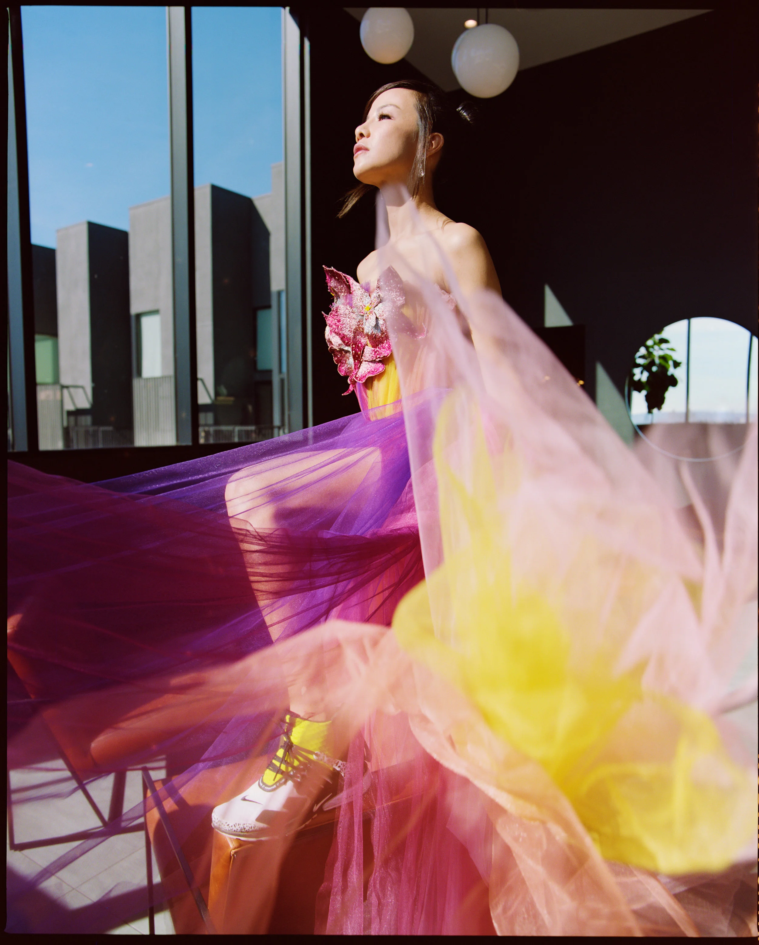 Dress by Schiaparelli and Trainers by Nike .