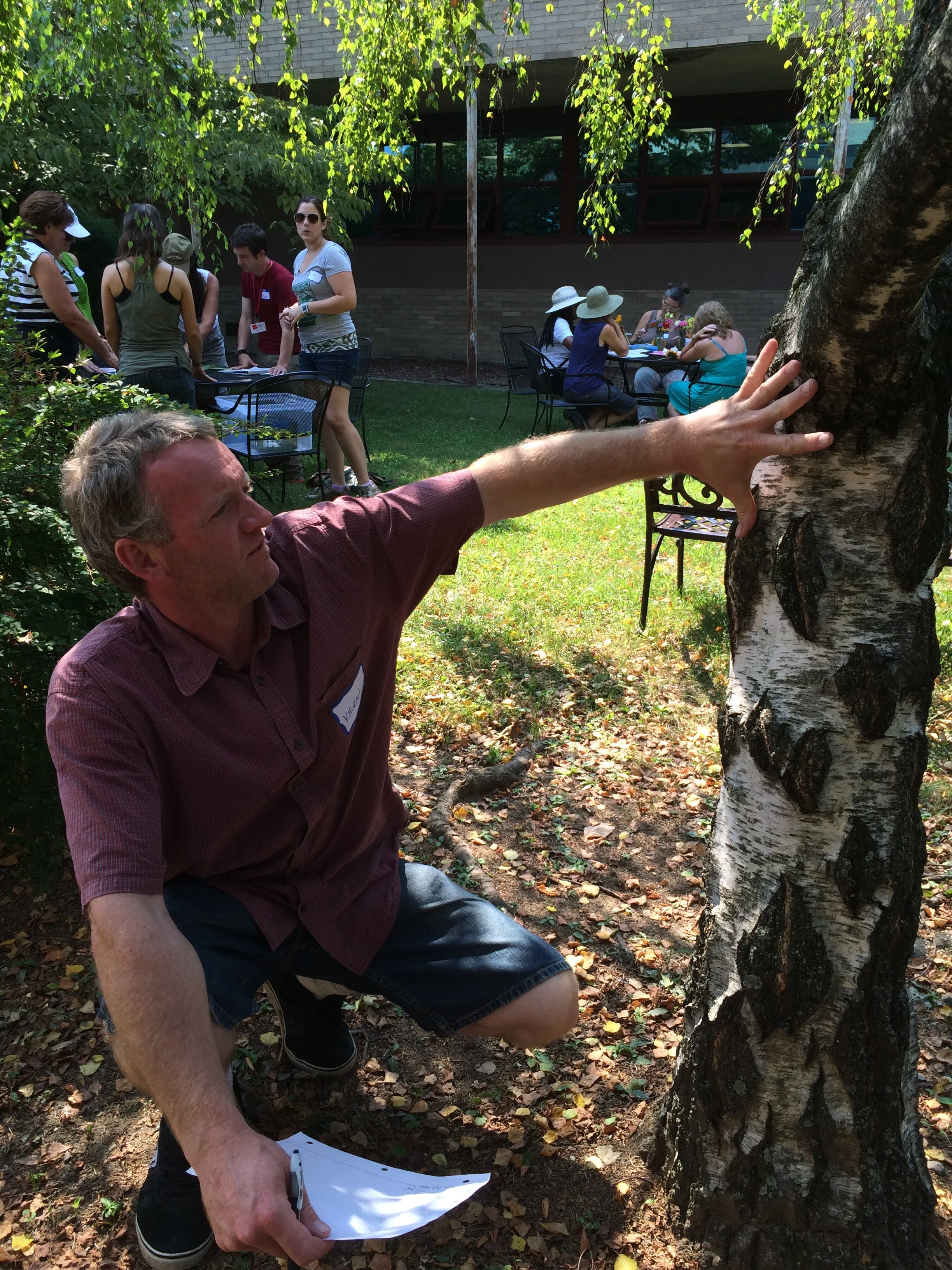 Kieran Hales from the Primrose Hill School measures a tree using hand spans to demonstrate a lesson from Math in the Garden .