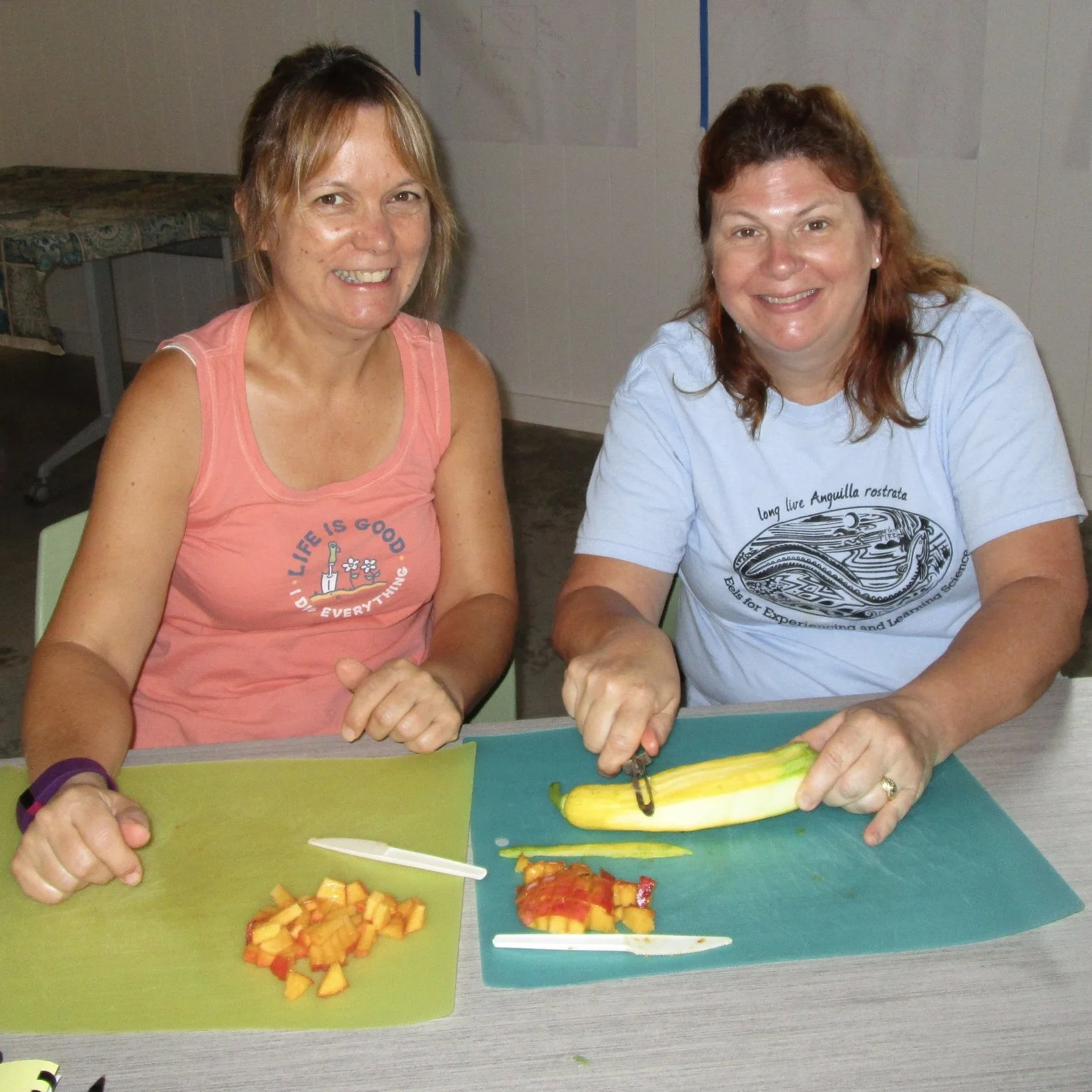 Suzi (left) and Mary make squash ribbons to add to the kale salad.