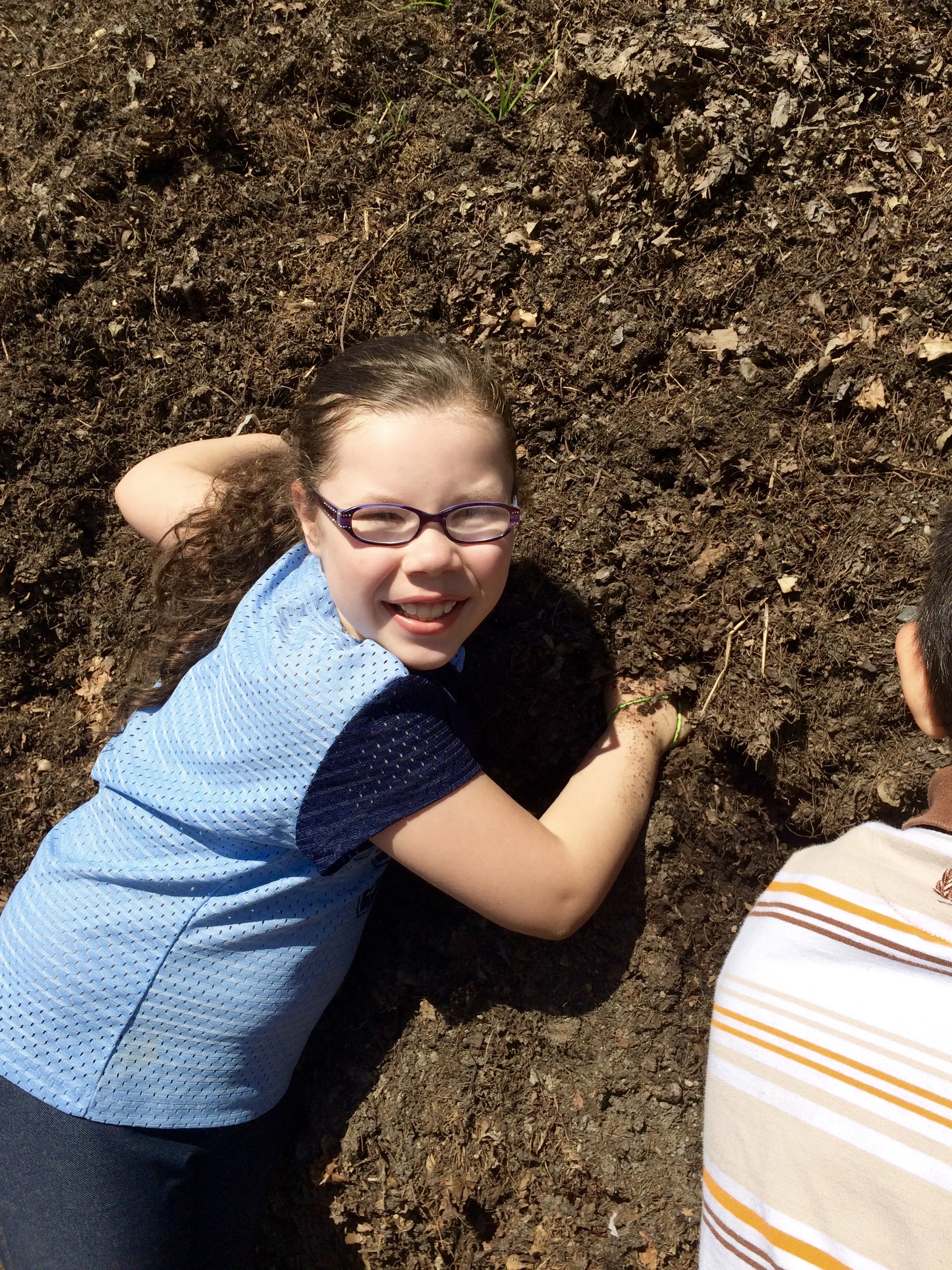 Visiting 2nd graders took turns reaching into the giant compost pile to feel the warmth of decomposing leaves inside.