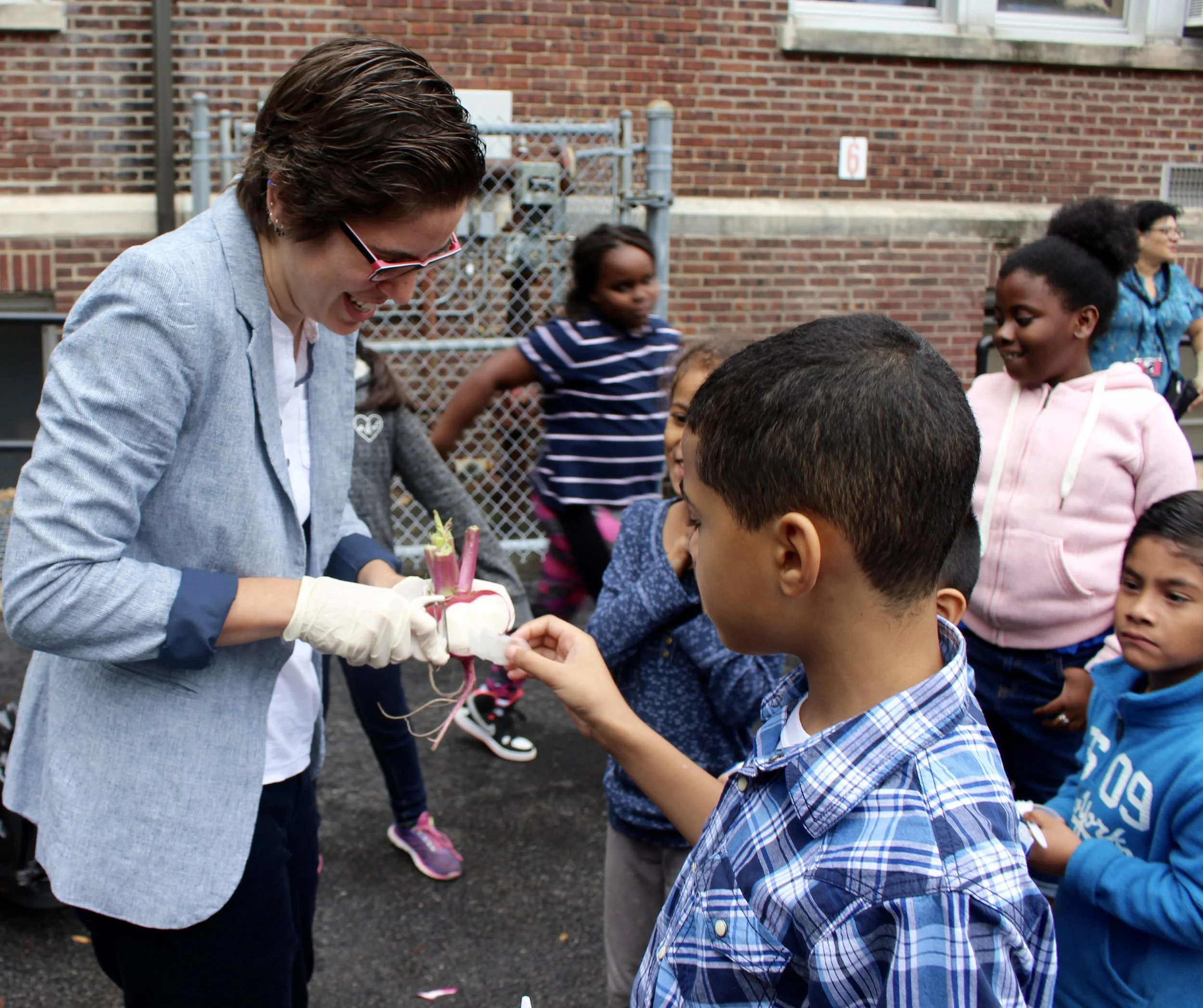 Jamie offers everyone a taste of the scarlet turnips. They were a big hit!