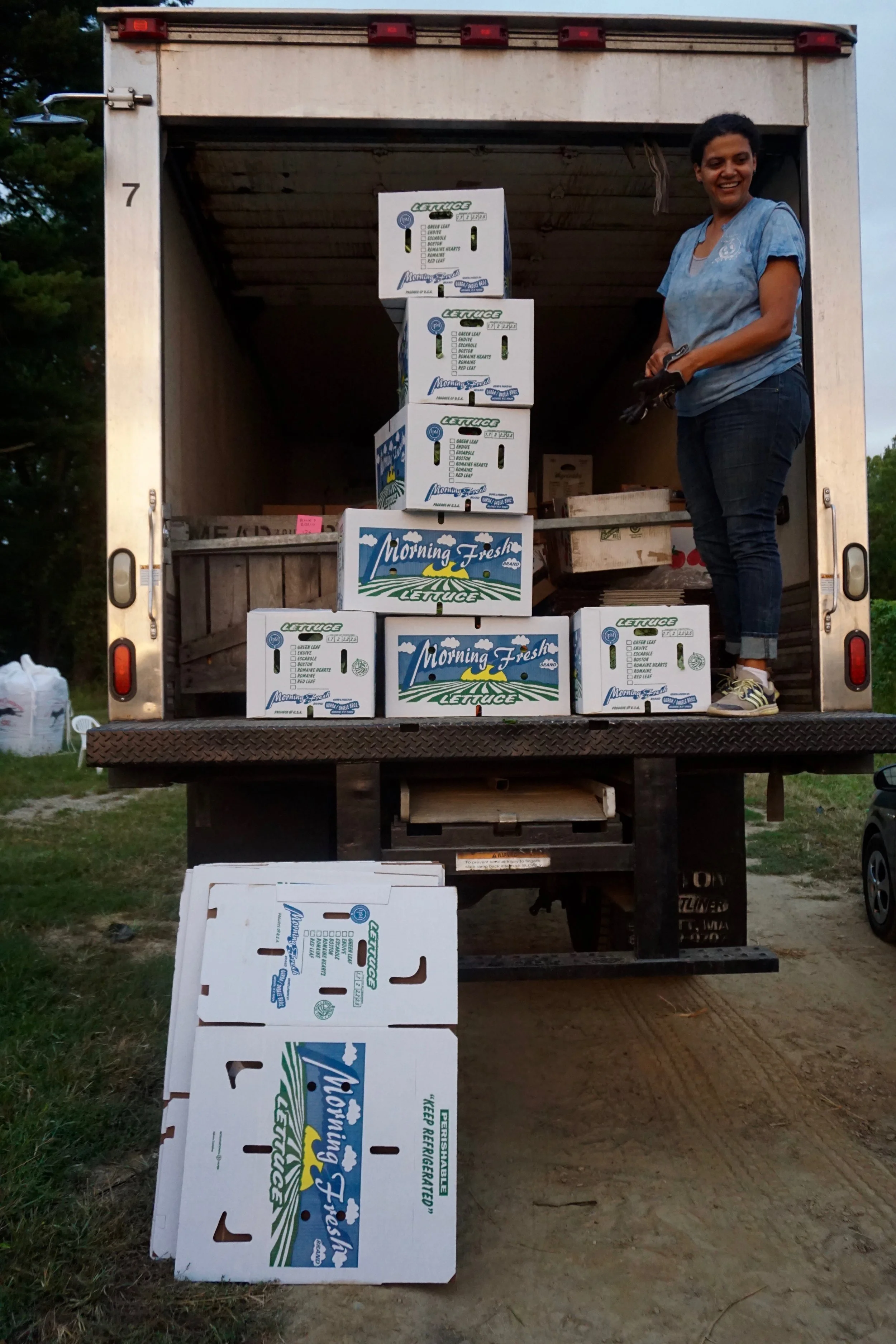 Photo credit: Eilif Ronning, PFP Media Intern Stiles stands on her “Gleanmobile” with fresh gleaned greens ready for delivery