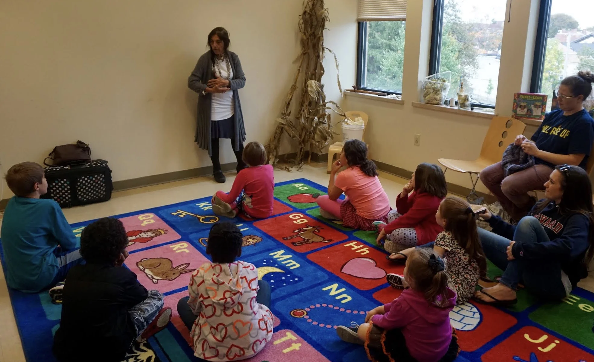 Photo by Elif Ronning, Media Intern Children and adults listen attentively as Vickie Raabin tells the story of the corn husk doll.