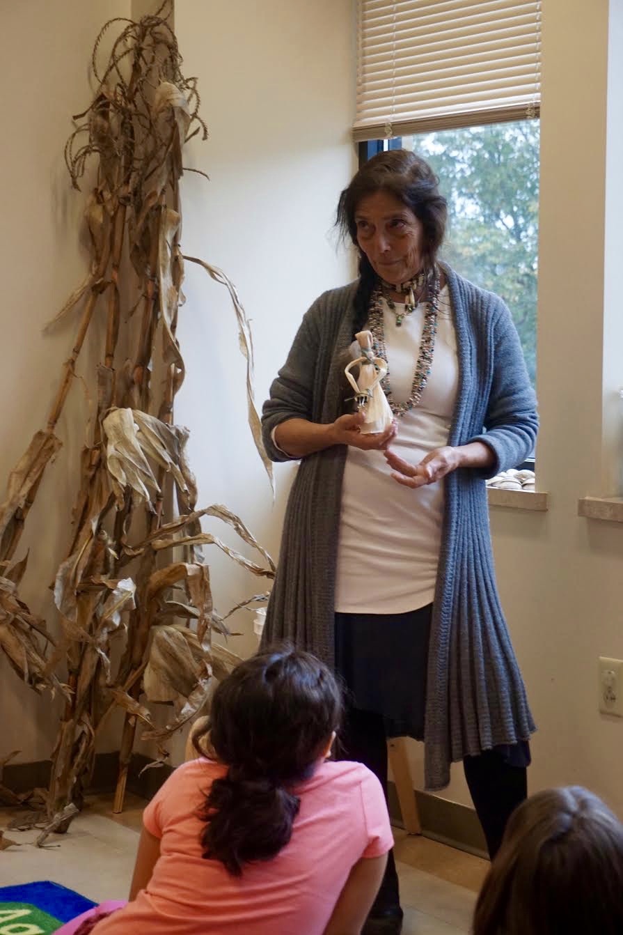 Photo by Elif Ronning, Media Intern Vickie Raabin holds up a finished corn husk dolls as an example.