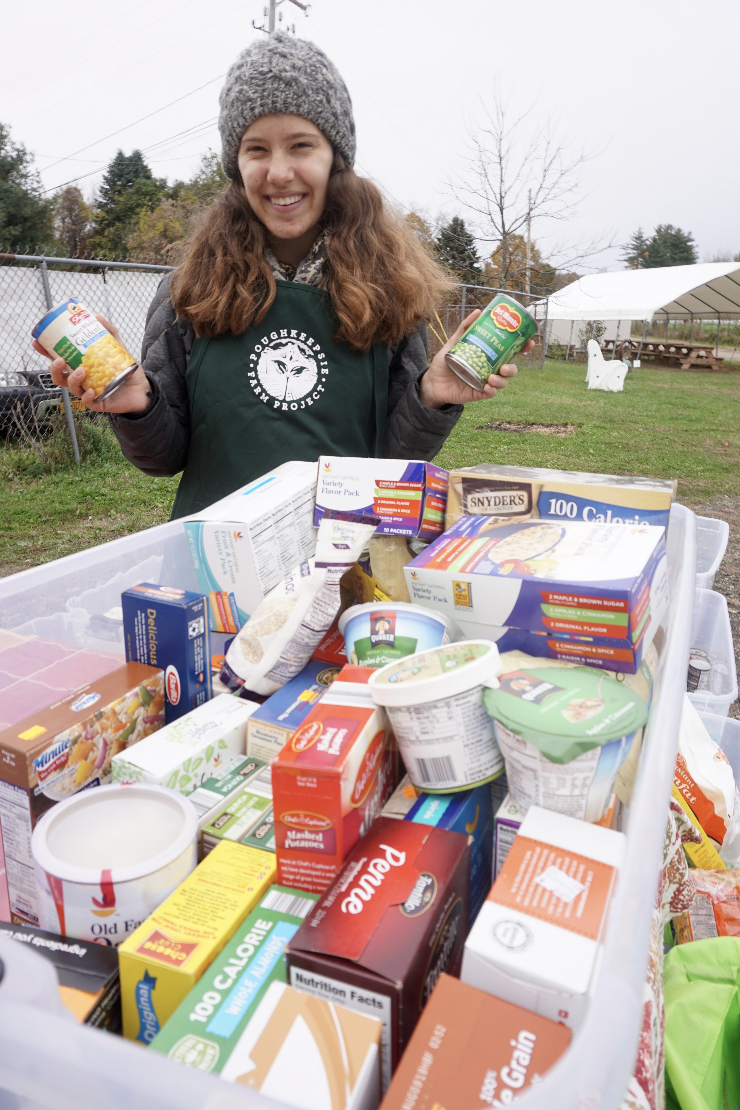  PFP Intern Lucy holds up some newly donated cans of veggies! 