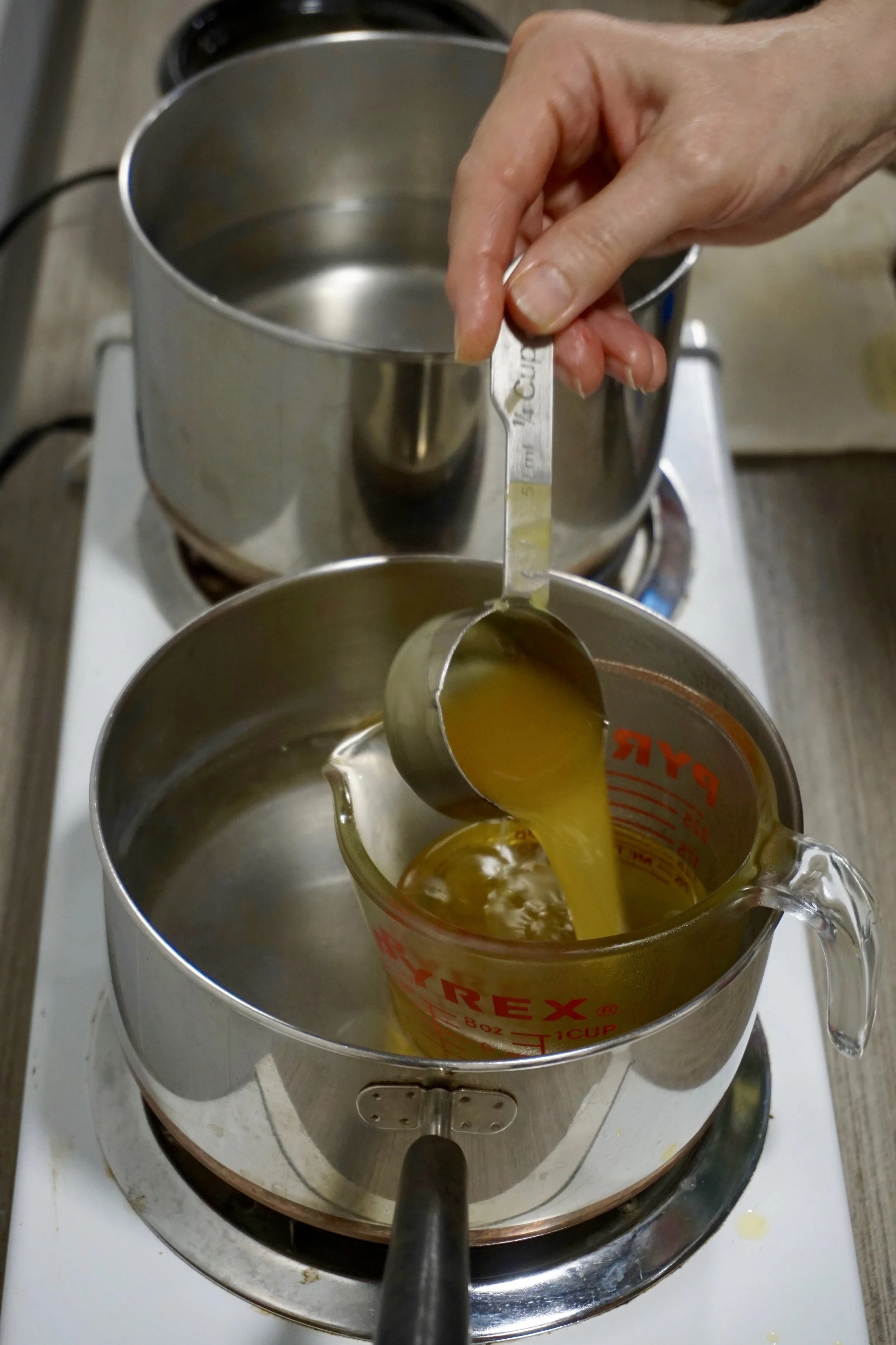 Above: melted bee’s wax being combined with the infused calendula oil