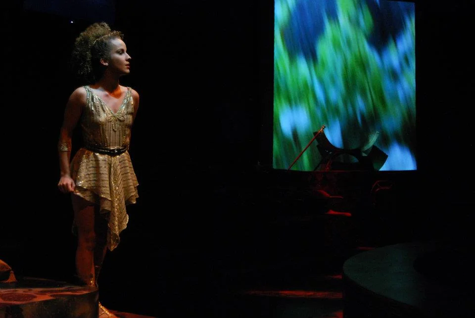 Amore looks on in L'incoronazione di Poppea at Oklahoma Opera Theatre. Directed by William Ferrara, Scenic Design by Rick Reeves, Costumes by Lloyd Cracknell.