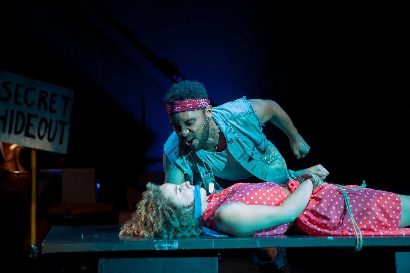 Hot Blades threatens Hope in Urinetown at Monumental Theatre Company. Directed by Jenna Duncan, Costumes by Kelsey Sasportas, Photo by Josh Rudy.