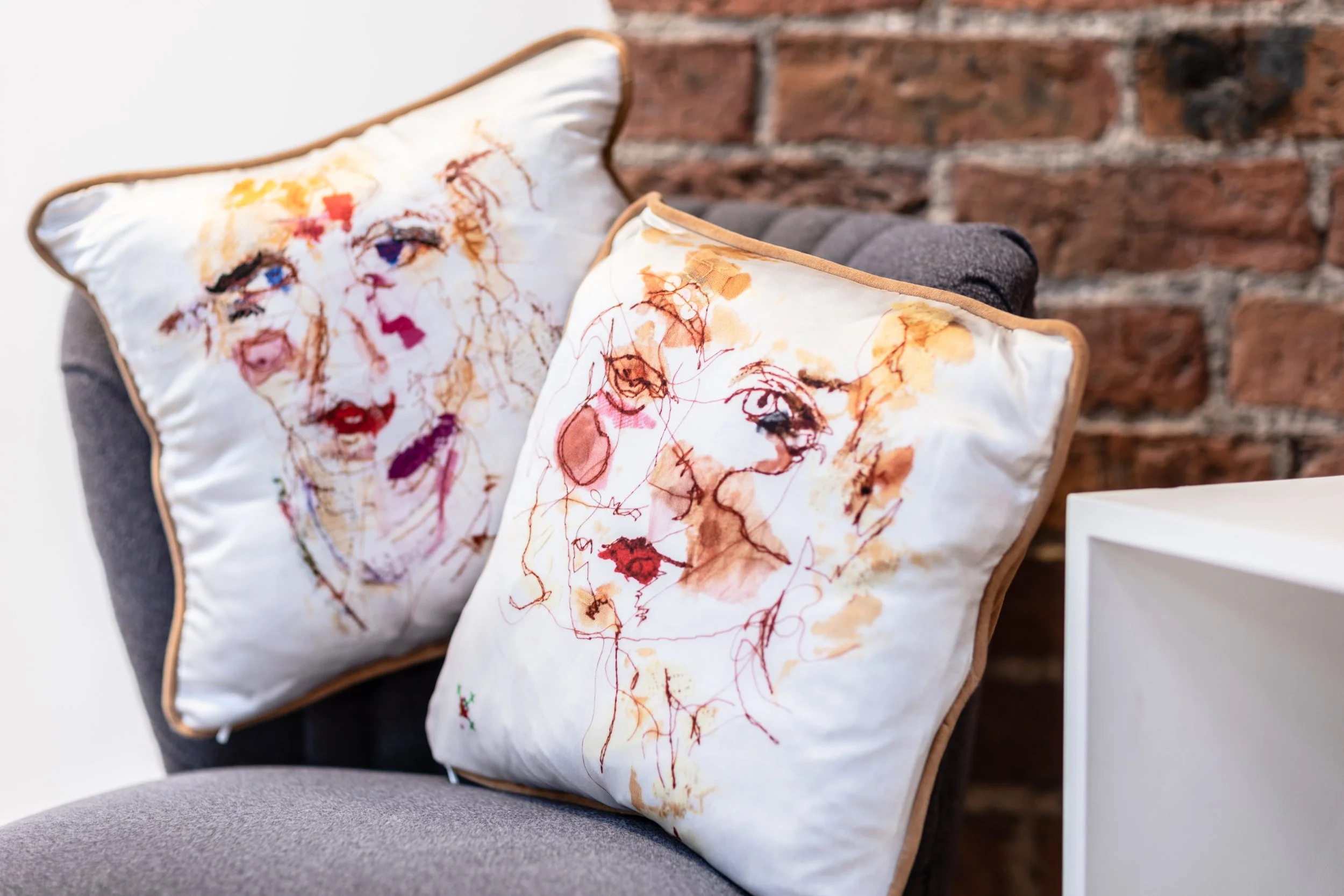 Two of my stitched portraits digitally developed for cushions (2024)