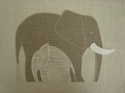 A sheltering mother elephant above in Irish Linen and Enzyme Washed Linen and cream. The Elephant Mother applique is 12" wide. $36.00 per motif.
