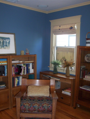 A standard lined Roman shade is inside mounted on a window with the Madison Iris applique used sideways.