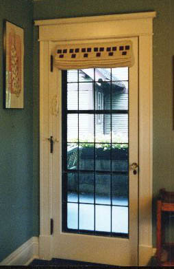 Here is an outside mounted standard shade on a door with the Three Square stencil in mahogany.