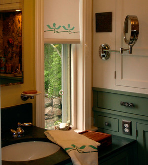 Shown here is a stenciled roller shade with the Iris Border stencil, in teal and forest and a coordinated guest towel.