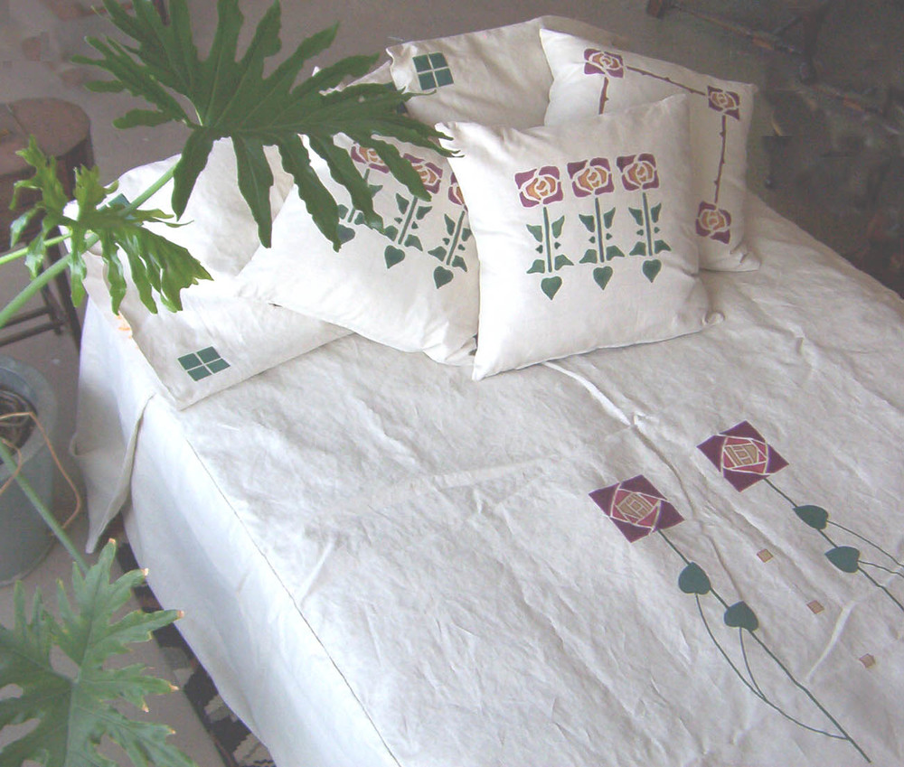 Custom Macintosh applique on white pillows and bedspread in dark red, forest and antique gold.