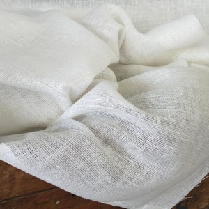 Linen Scrim, Oyster: loosely woven and slightly coarse, like sturdy net. Lovely for stencilling & pin stitch. We do not applique on this fabric. 54" wide, oyster. Should not be lined. $23.00 per yard.