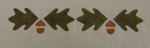 Acorn Border: A cheery, informal version of the popular motif, show here in loden, terra cotta & antique gold, 7" repeat. $40.00 per repeat. Single acorn wth leaves for $20.00.