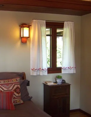 Simple rod pocket curtains with an Iris stencil border. You can sense the light quality of the handkerchief linen.