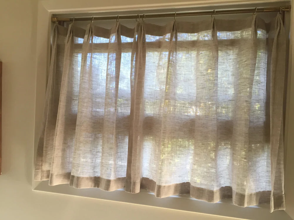 Cafe style curtains in the kitchen are 1 1/2 fullness with pleated top and rings. Fabric: Handkerchief Linen - Natural