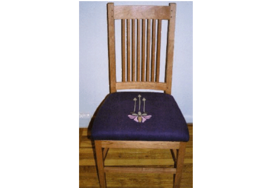 A craftsmen dining chair upholstered in appliqued linen.