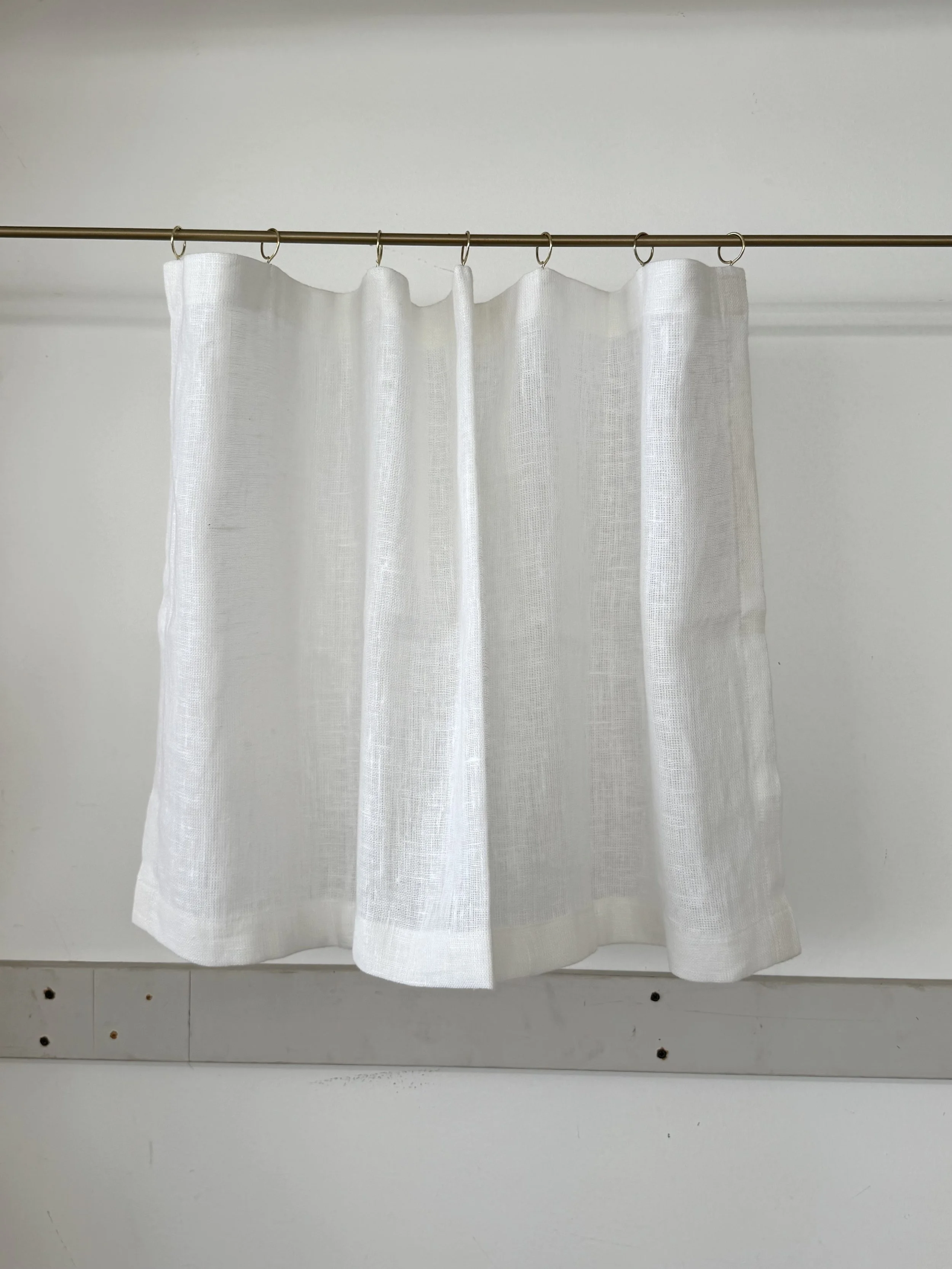 linen scrim curtain with brass rings.jpeg