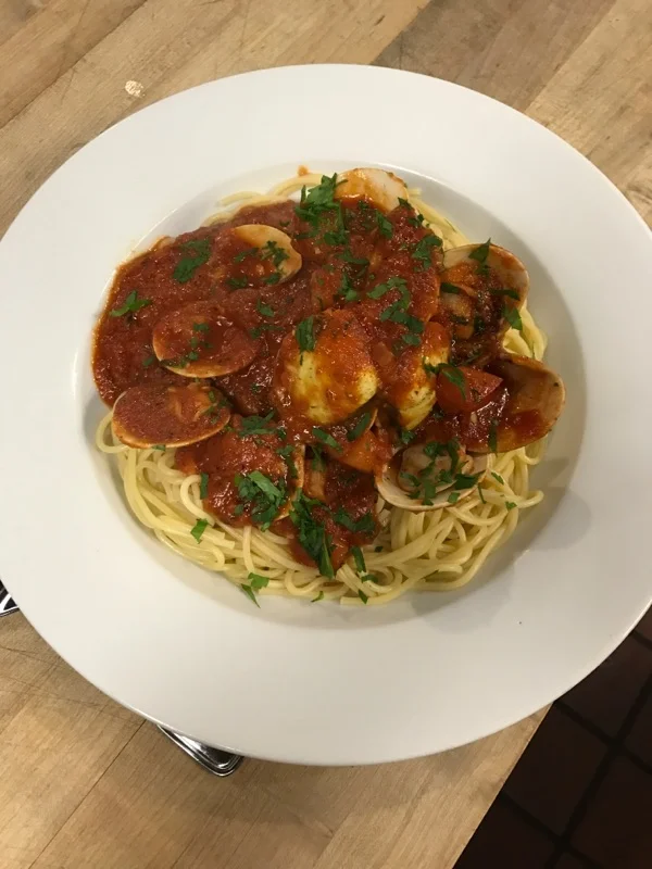 Clams in a spicy tomato sauce on a bed of spaghetti