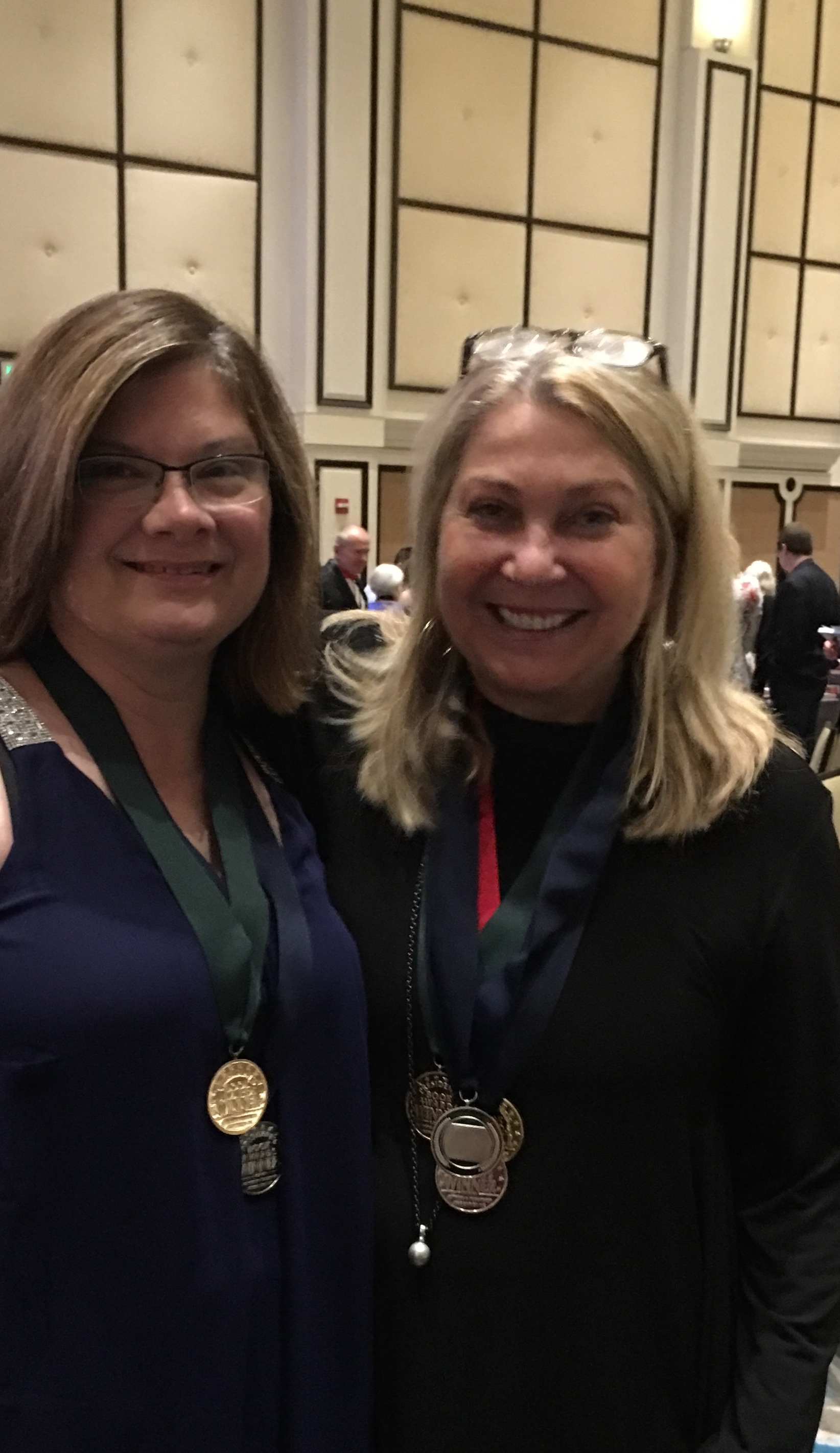 Mary Andrews and Jayne Rose-Vallee pose with their winning medals.