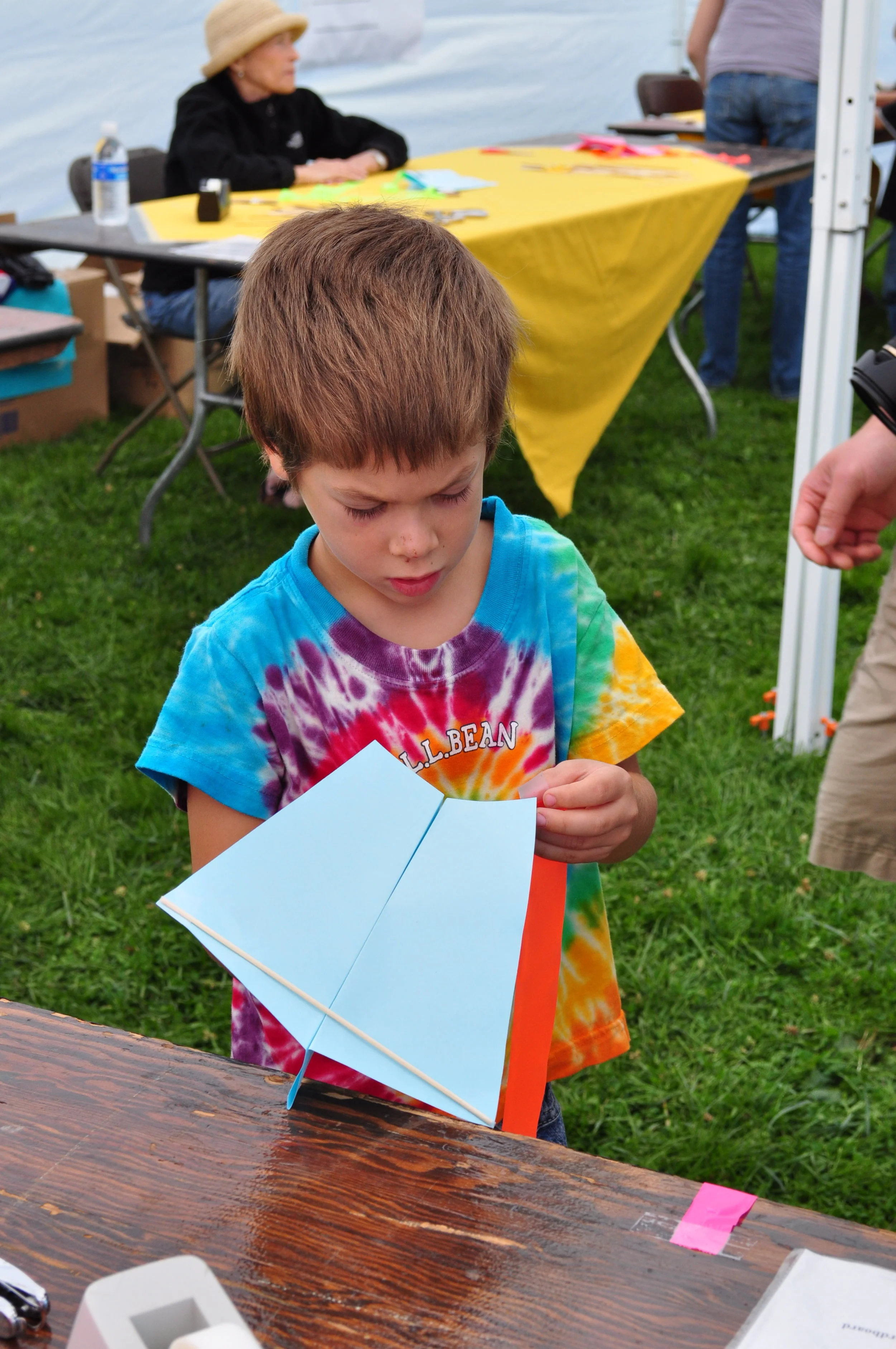  At the Make-A-Kite Booth, kids folded simple kites to fly. 