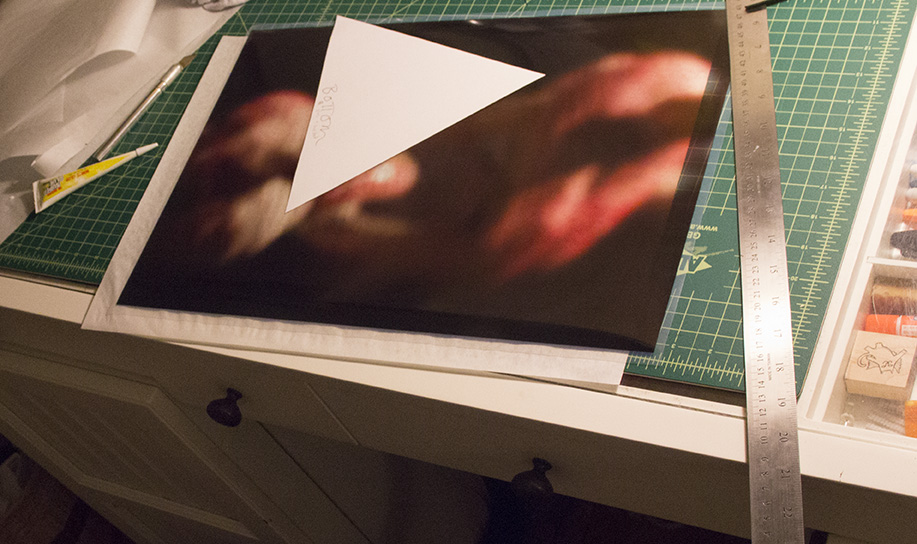 Cutting the transparency to fit the tetrahedron.