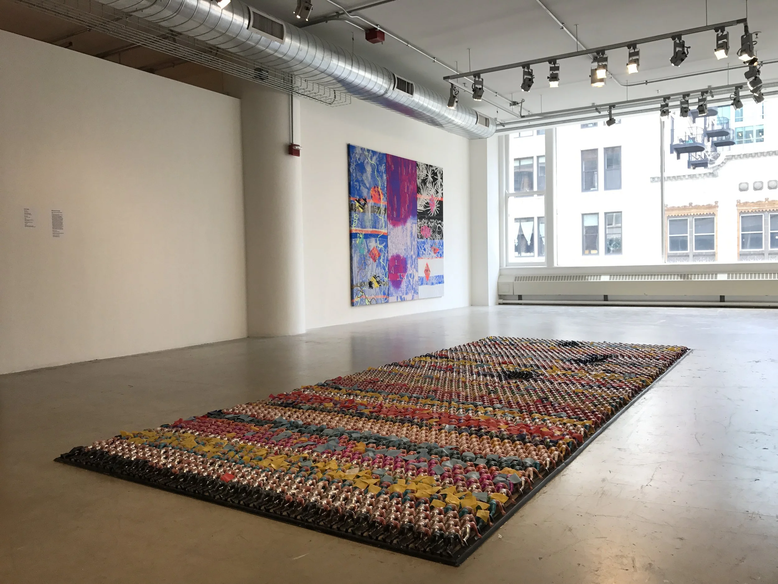  Floor Piece (one minute on/one minute off)  2017  15ft x 6ft  4,410 hand casted PVC dolls, enamel paints, plastic cloth, rubber nosing 