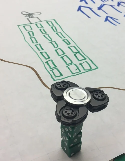 One of my favorite parts... Anakin built a dice tower with a spinner on it. Another player mentioned "dicescraper" as a pun (genius!) Gina took all this and ran with it, and Anakin drew a flying skyscraper, which ended up being a focus in them solving their issues.